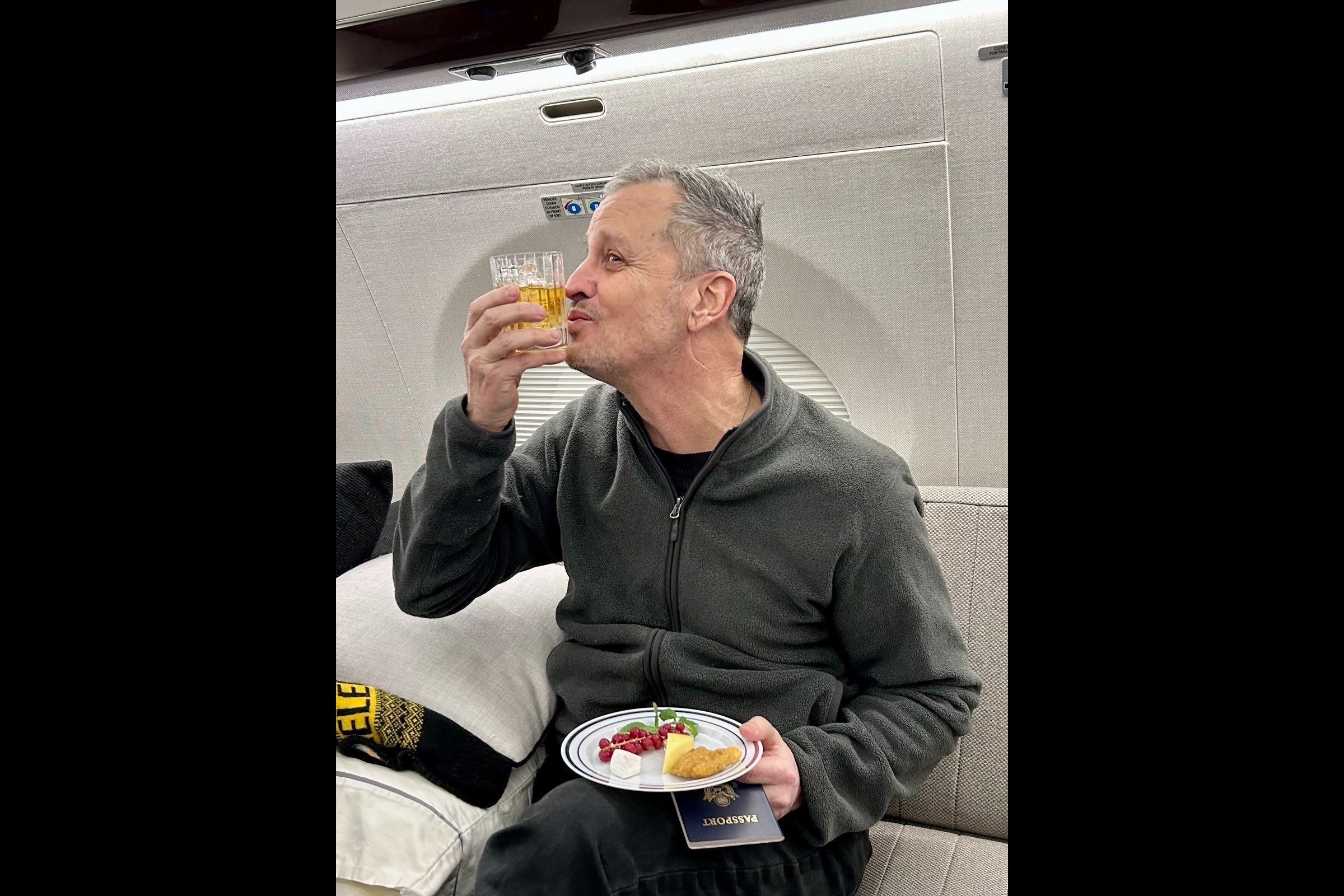 Fogel pictured on the plane back to U.S. after release from Russian prison