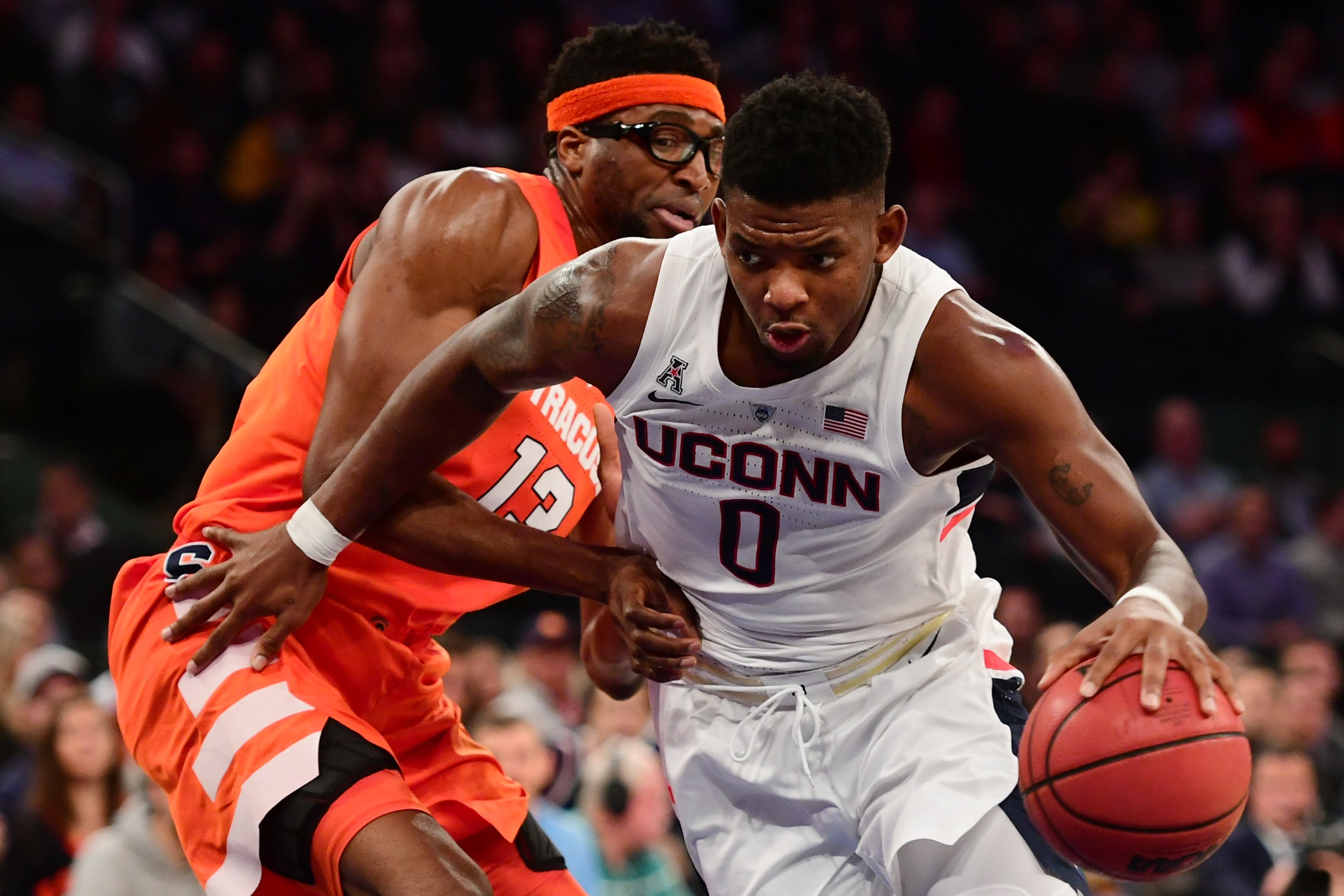 Eric Cobb (right) pictured playing for the University of Connecticut in 2018. This week, he was arrested in Florida in connection with his mother's death