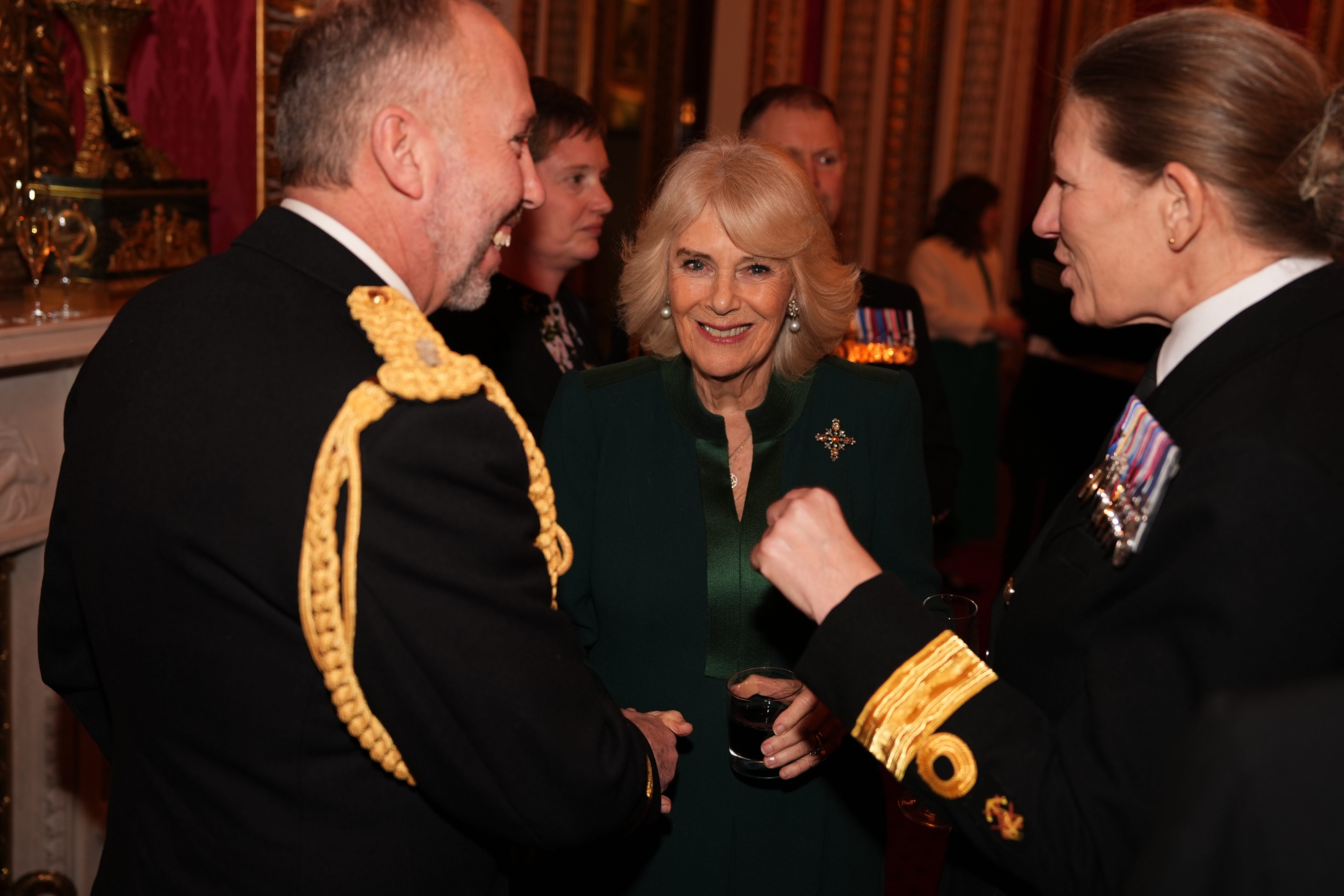 Queen Camilla meeting guests as she hosts a reception at Buckingham Palace (Jordan Pettitt/PA)