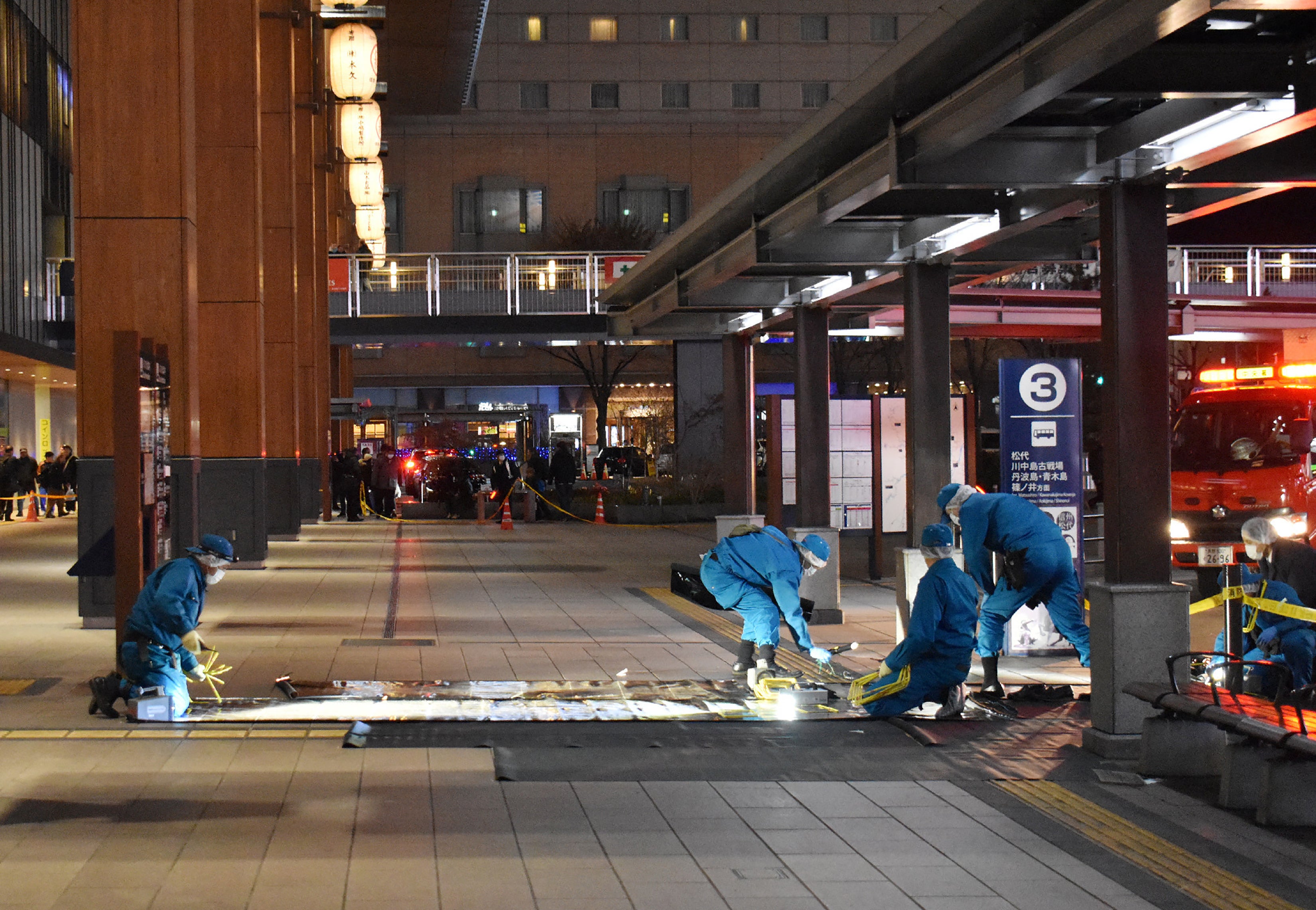 File. Investigators inspect the scene outside the JR Nagano train station after a man stabbed three people at a bus stop in the city of Nagano, some 225km (140 miles) northwest of Tokyo on 22 January 2025