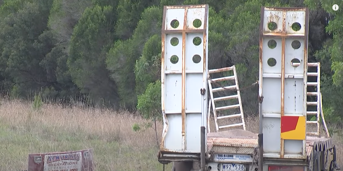 The truck was towing a trailer with an excavator. It is unclear what caused the crash