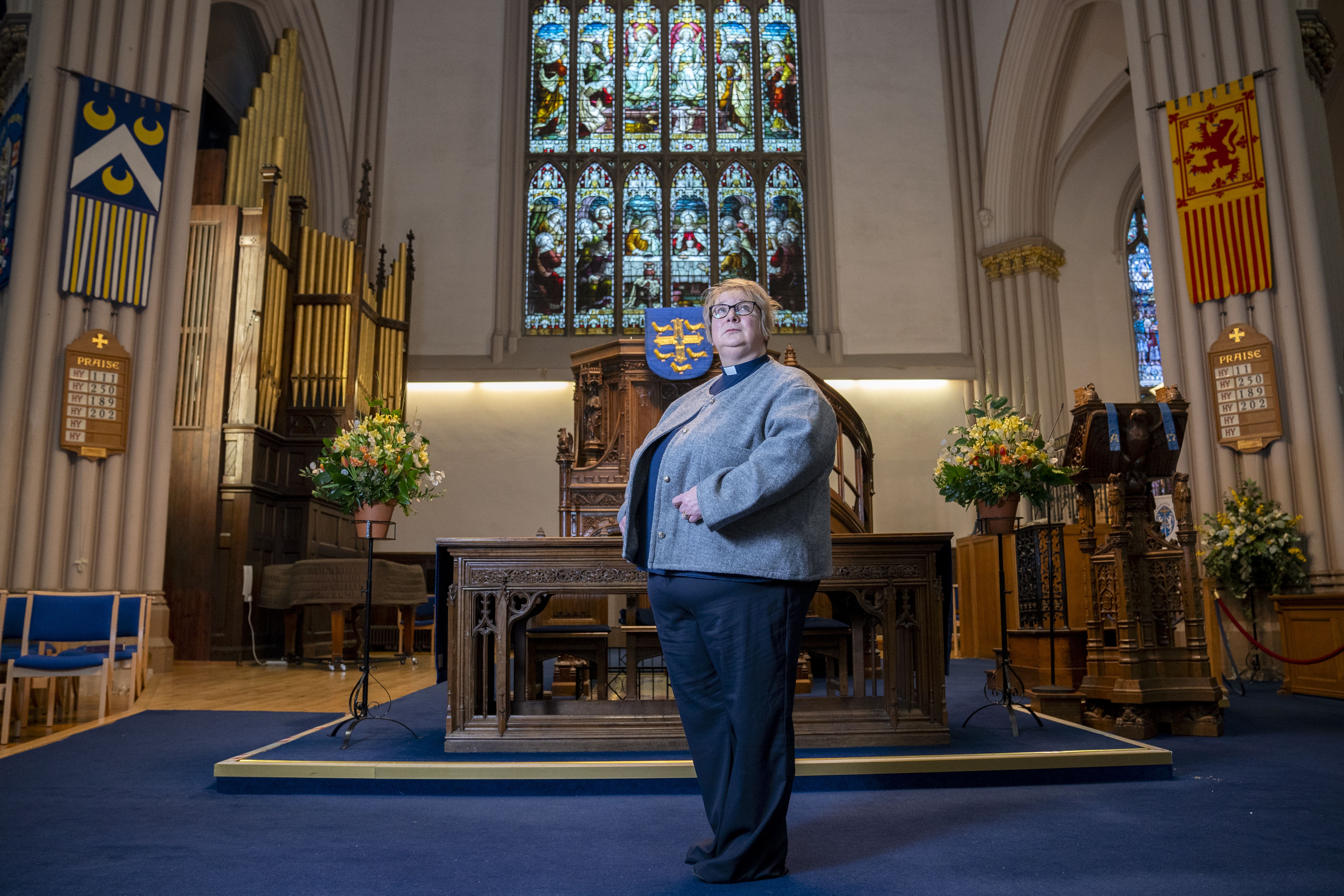 Rev Dr MaryAnn Rennie in front of the altar at the Abbey Church in Dunfermline (Jane Barlow/PA)