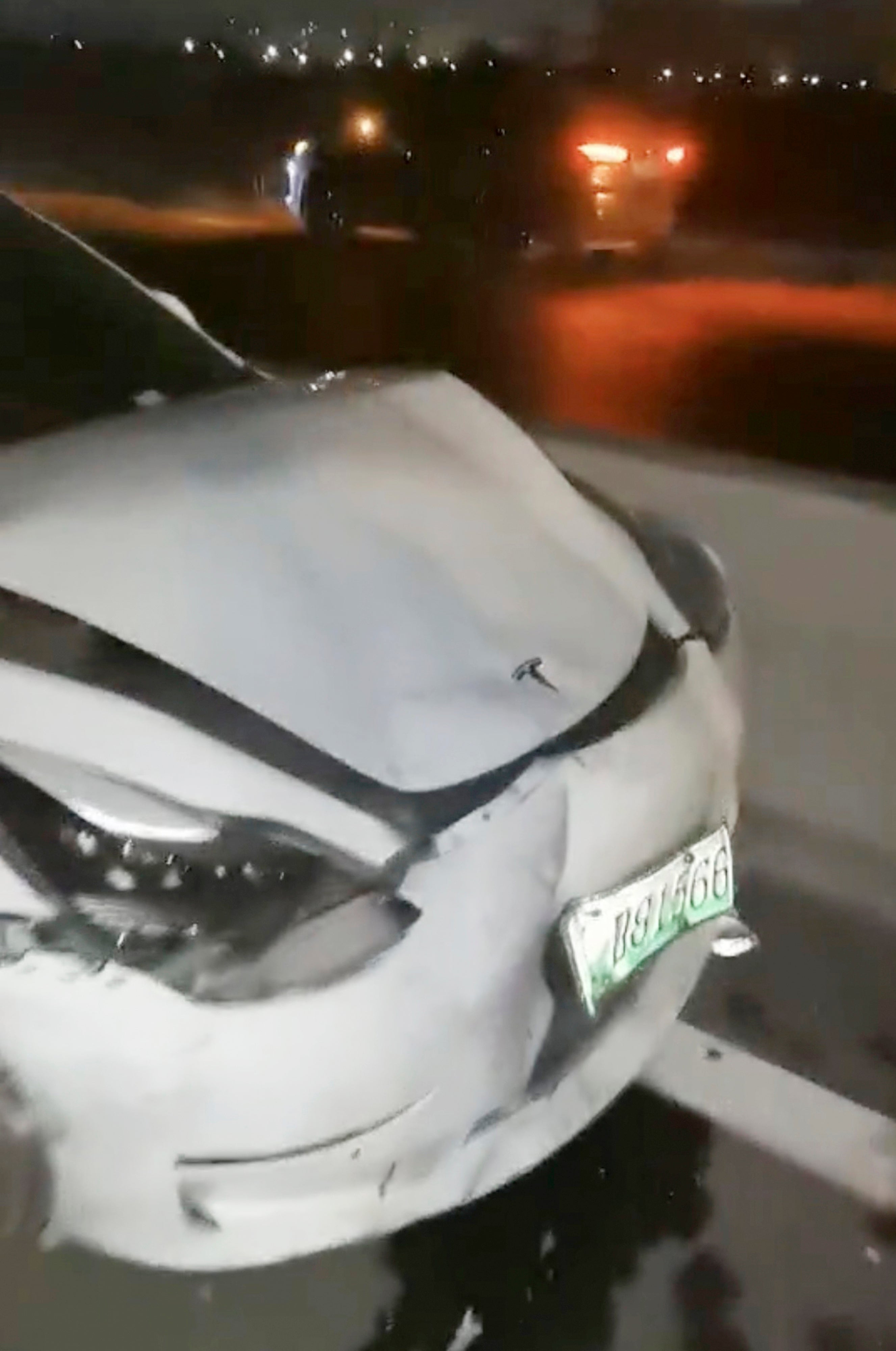 This photo provided by Zhang Yazhou shows damage to her Tesla Model 3, which her father was driving when it struck two other cars and crashed to a halt against a concrete barrier in Anyang, a city in central China’s Henan province, on Feb. 21, 2021. Zhang was in the passenger seat. Her mother and her one-year-old niece were in the back. (Zhang Yazhou via AP)