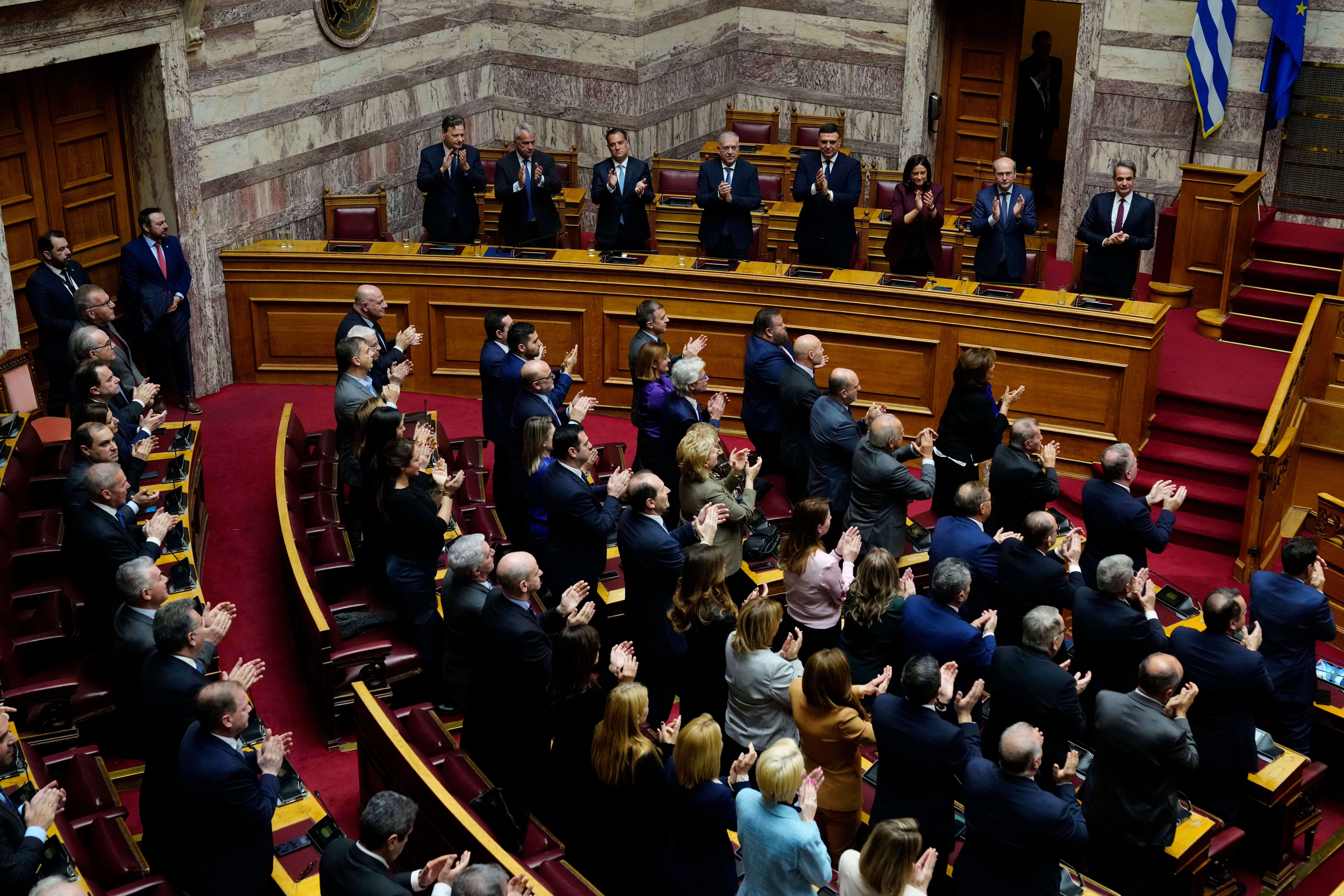Lawmakers of the New Democracy's ruling party applaud after the election of former Parliament Speaker Constantine Tassoulas as Greece's new president