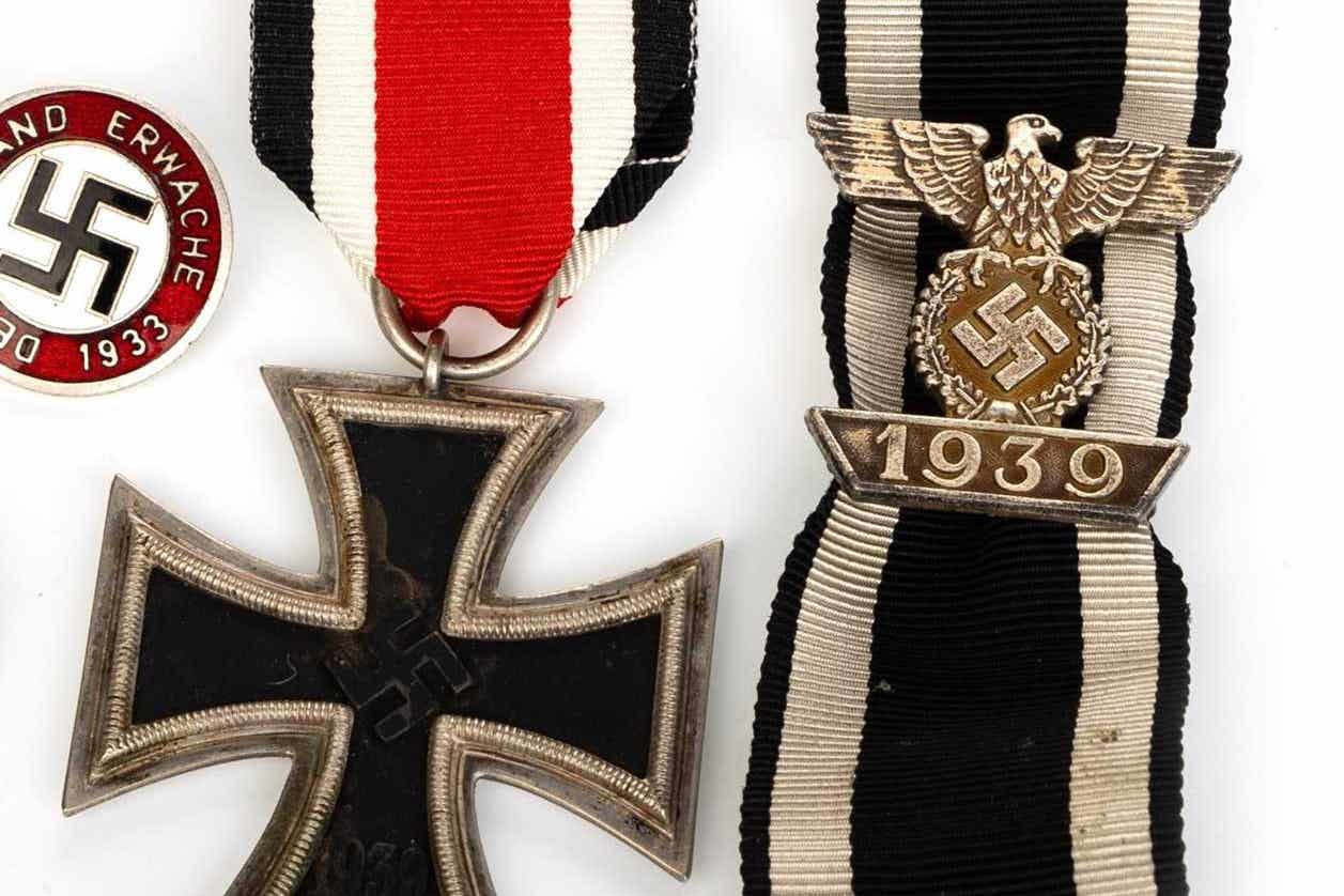 A German iron cross, ribbon and Nazi badge were among the artefacts up for auction