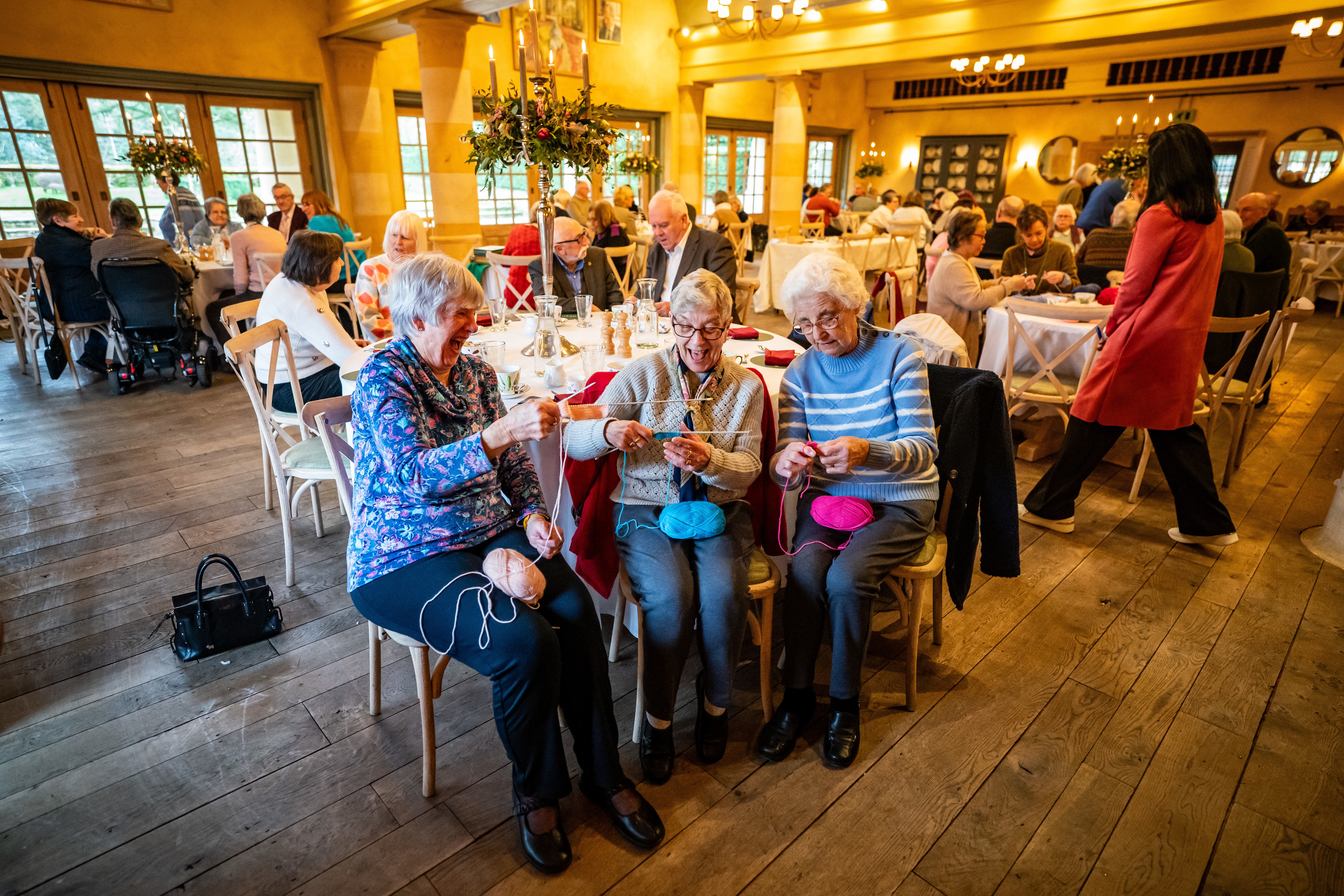 Visitors enjoying knitting while attending a Winter Warmers event in the Orchard Room at Highgrove, near Tetbury in Gloucestershire (Ben Birchall/PA)