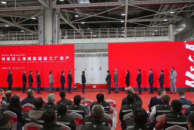 <p>Guests pose for photos during the ceremony marking the production launch of Tesla's Megapack energy storage plant in Lingang New Area </p>
