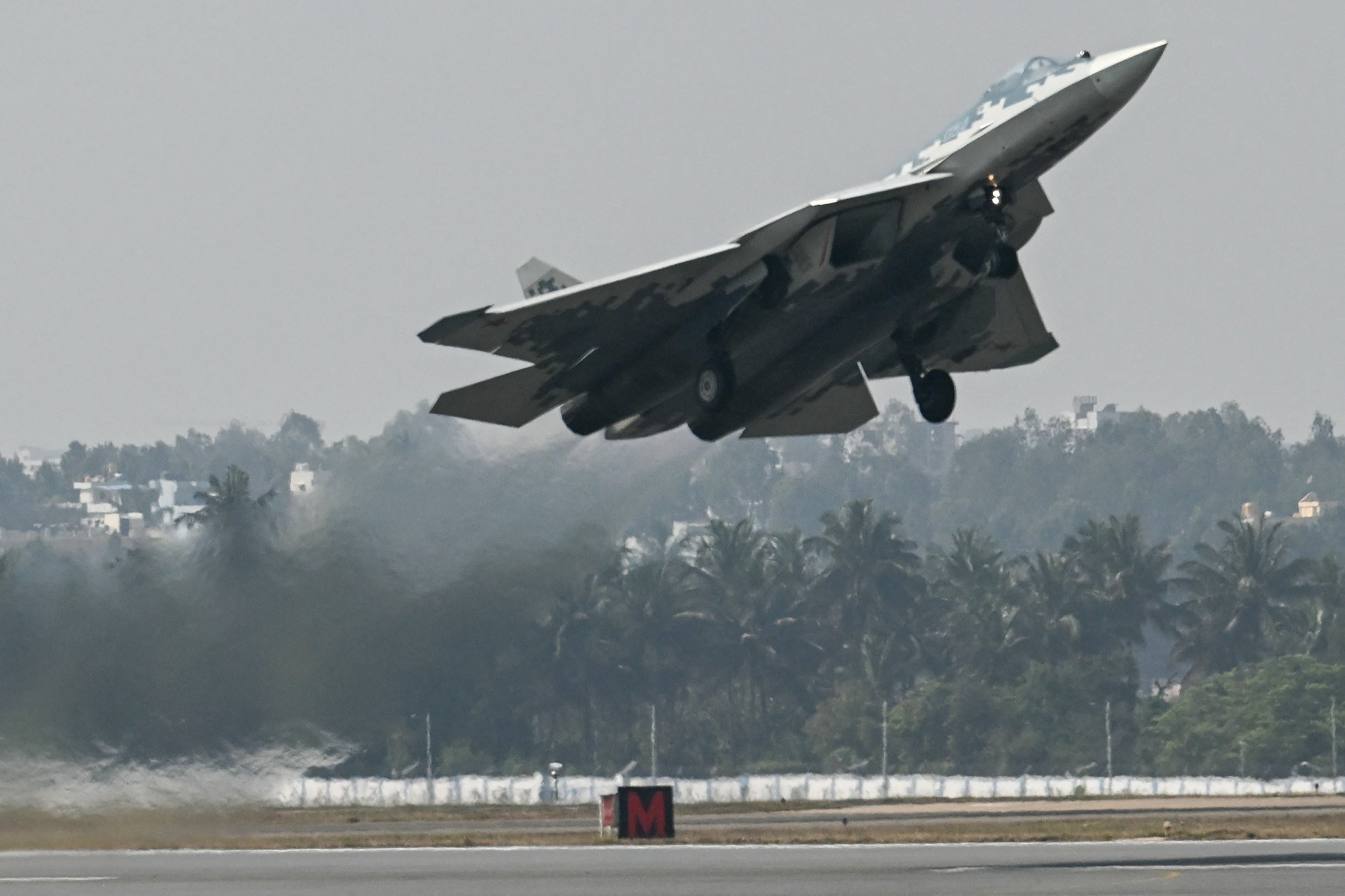 A Russian Sukhoi Su-57 fifth-generation fighter aircraft takes off during the inaugural day of the 15th edition of 'Aero India 2025'