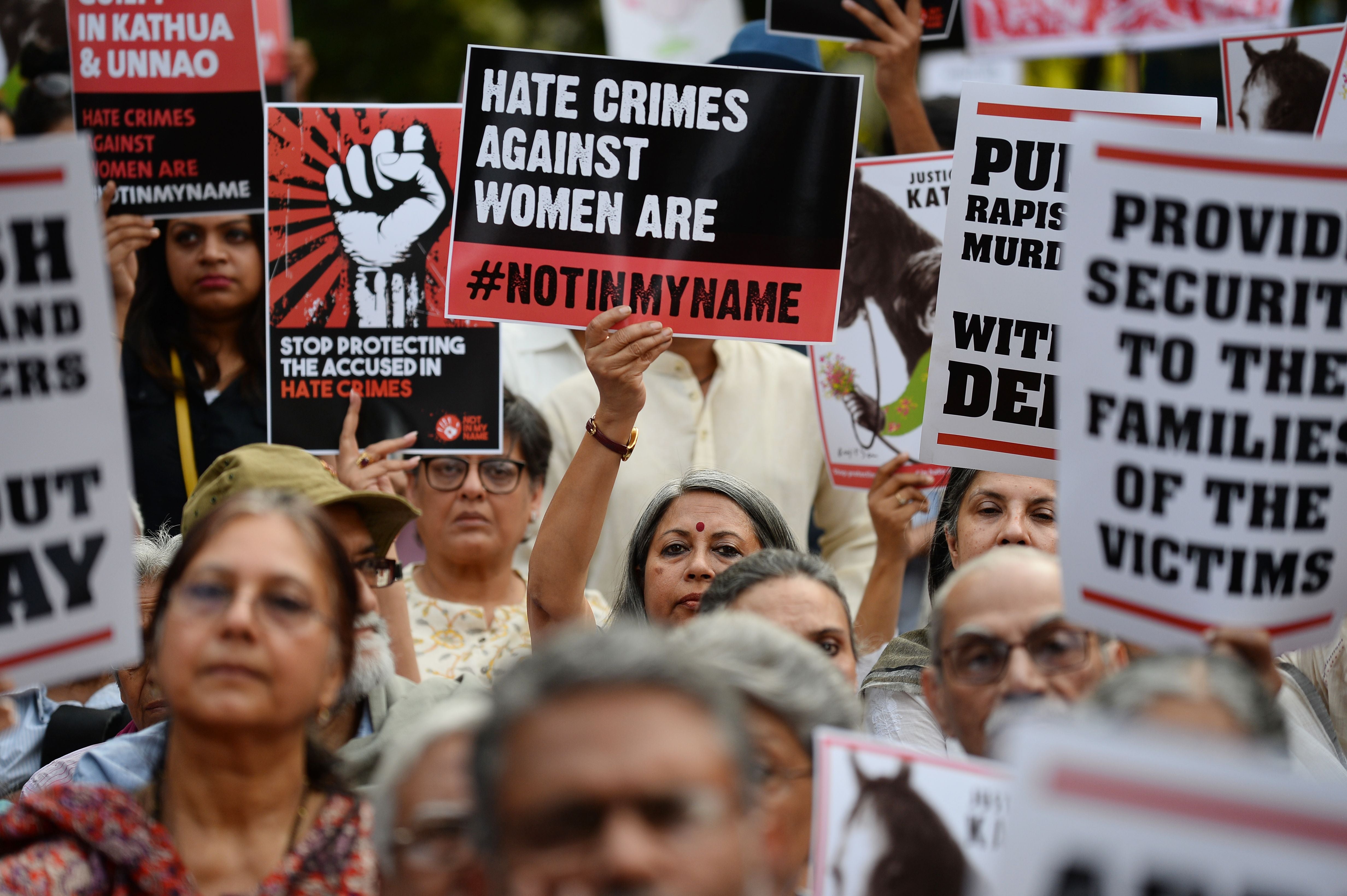 Indian demonstrators hold placards during a silent protest 'Not In My Name' in support of rape victims