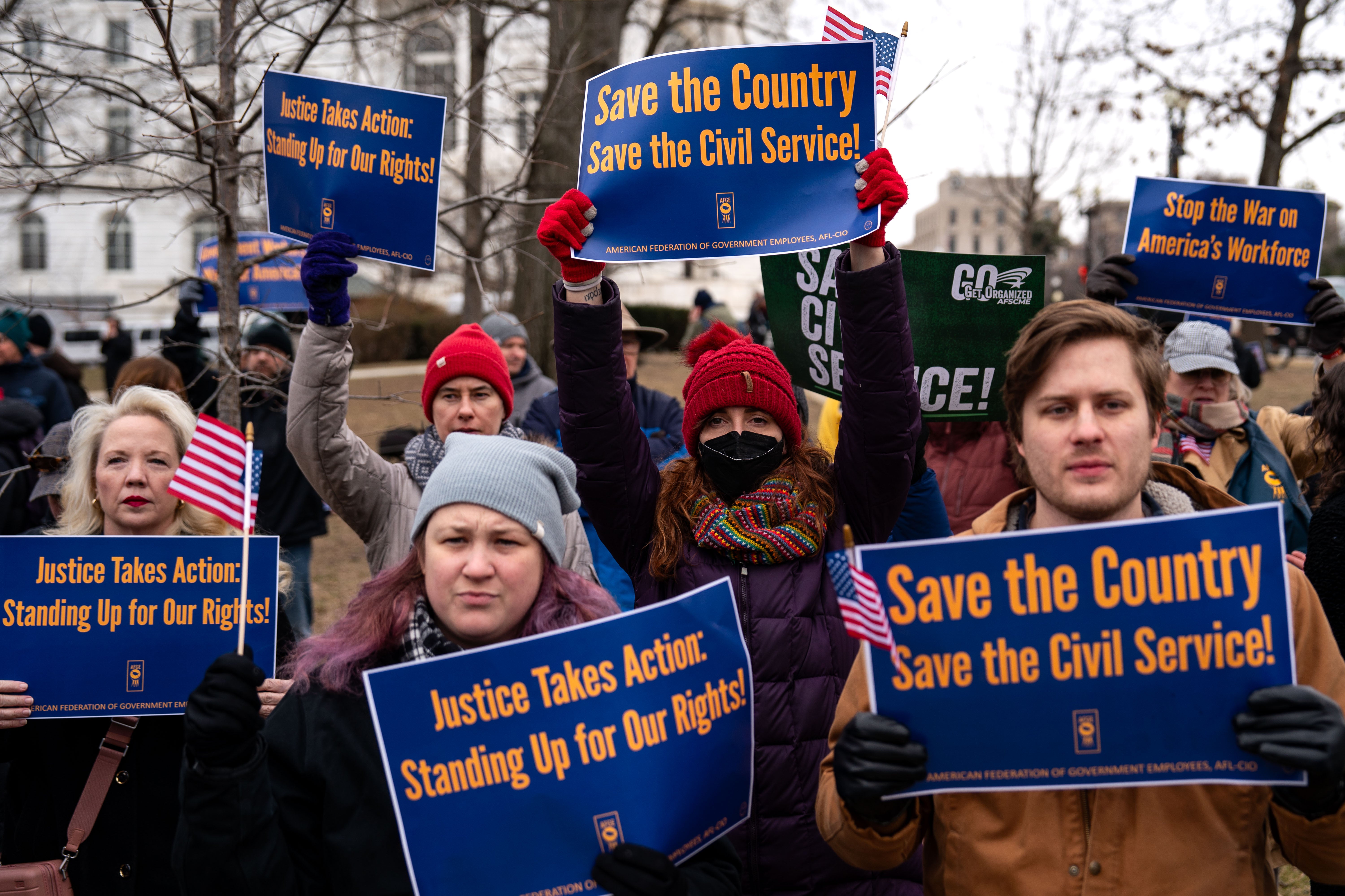 Those opposing the Trump administration’s massive cuts to the federal workforce protest against axing civil servants