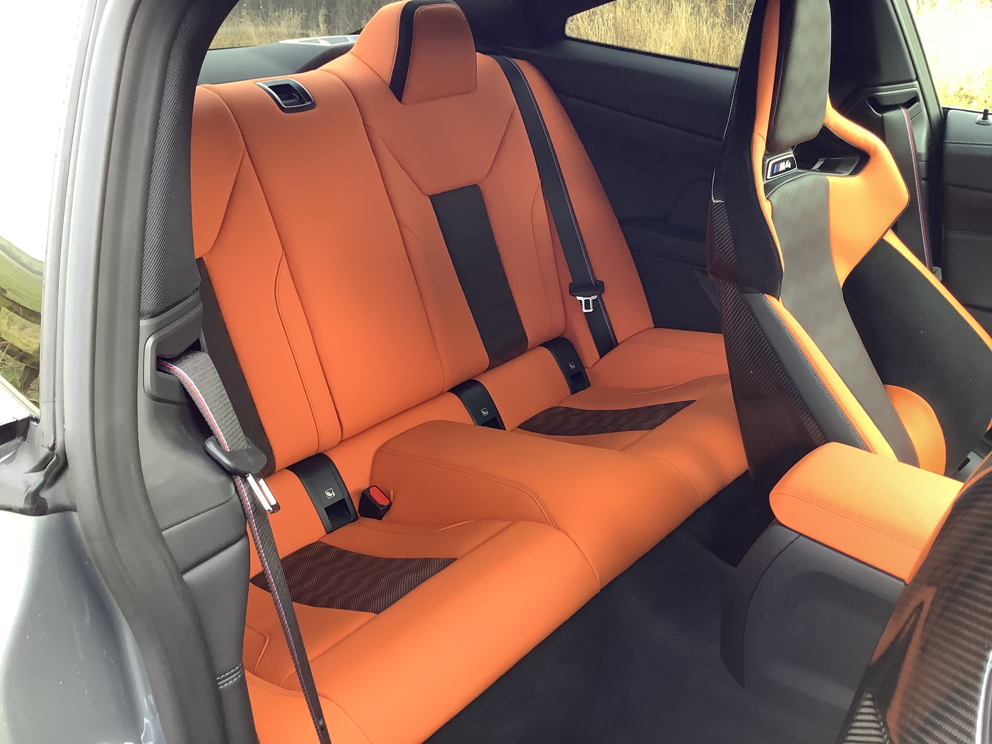 The sculptural carbon-fibre seats are firm, huggy and comfortable – but the big side-bolsters make getting in and out an undignified business