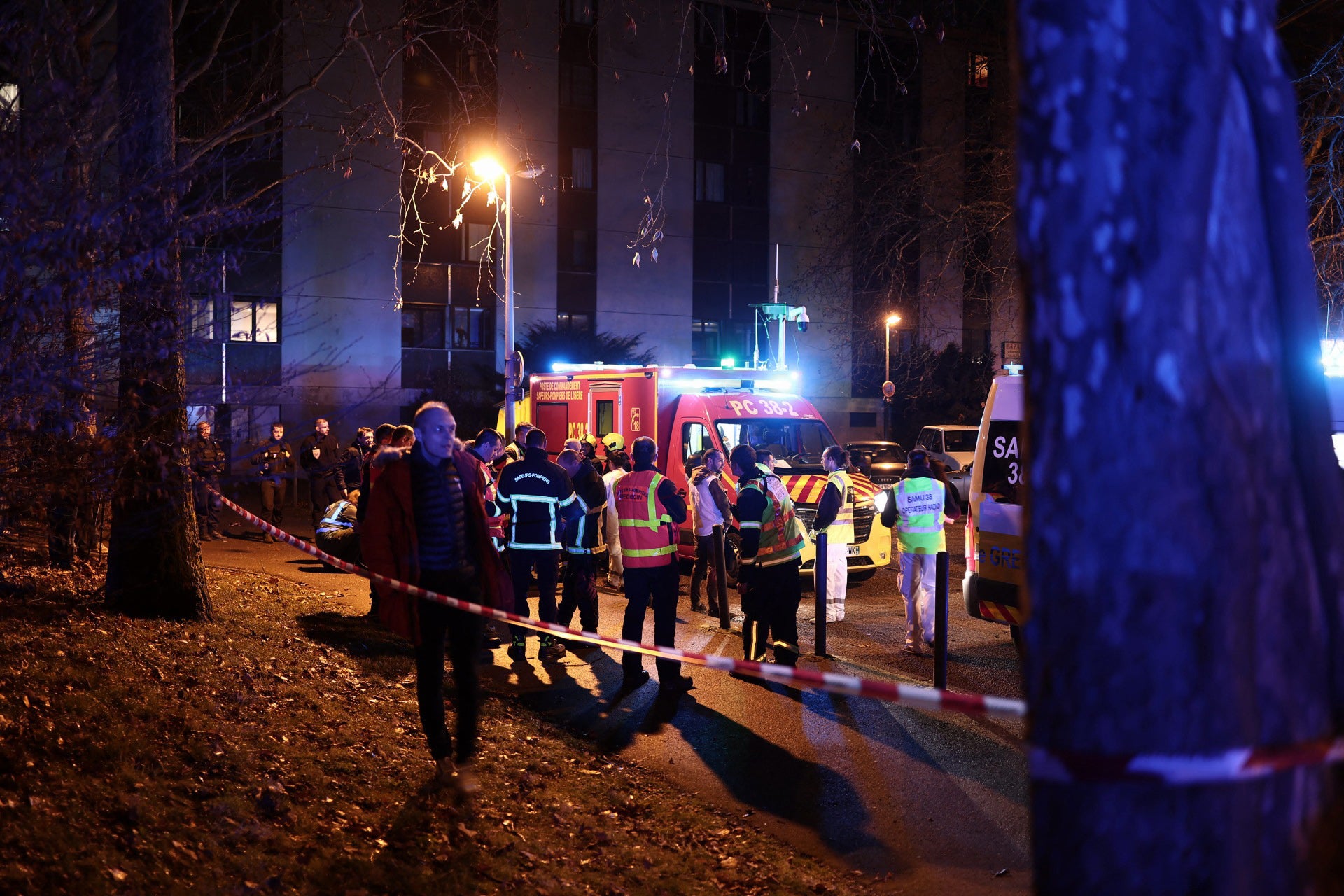 Emergency services work near the scene of the explosion at a bar where a grenade was thrown in Grenoble