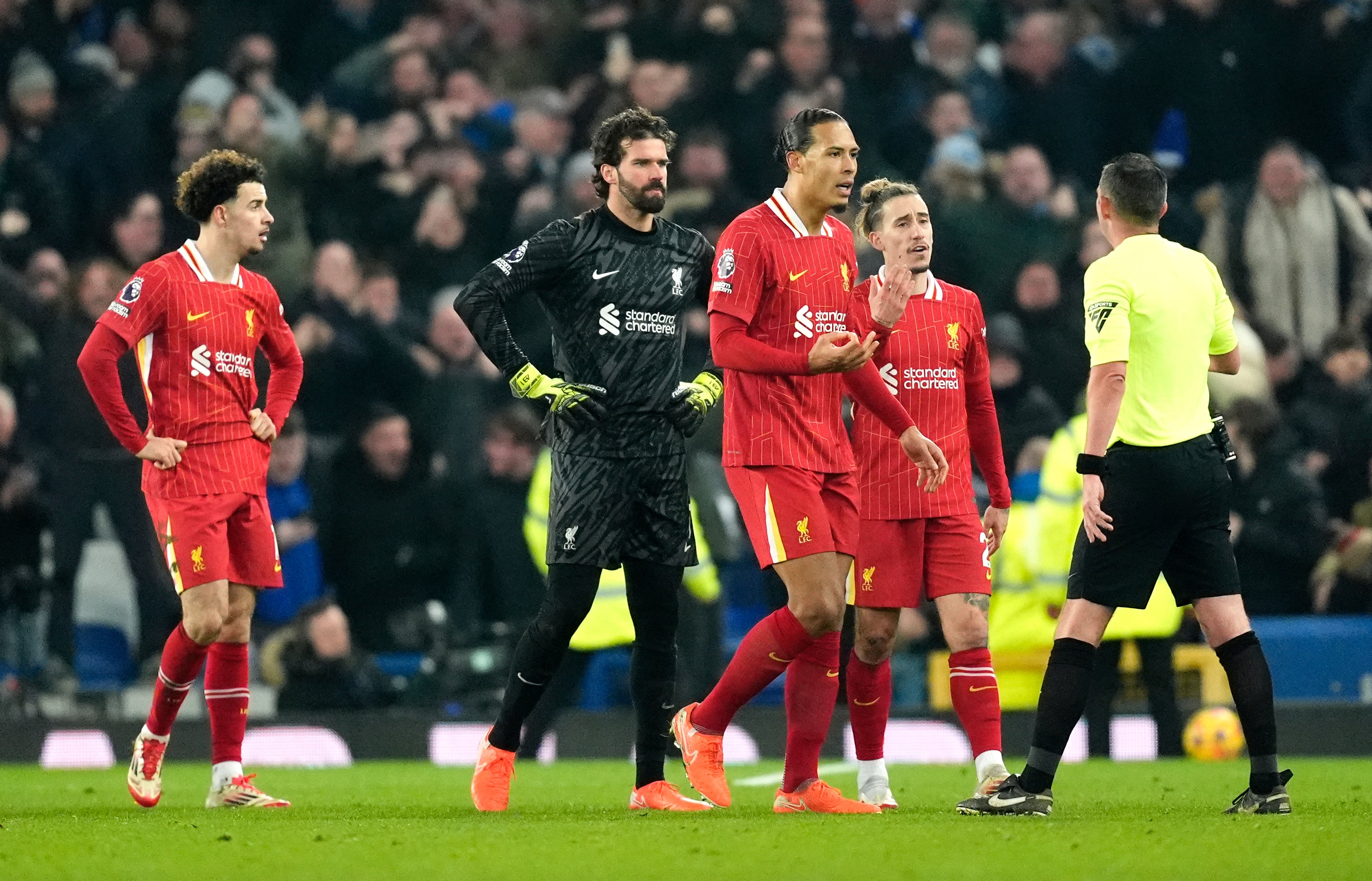 <p>Liverpool's Virgil van Dijk and players speak to referee Michael Oliver</p>