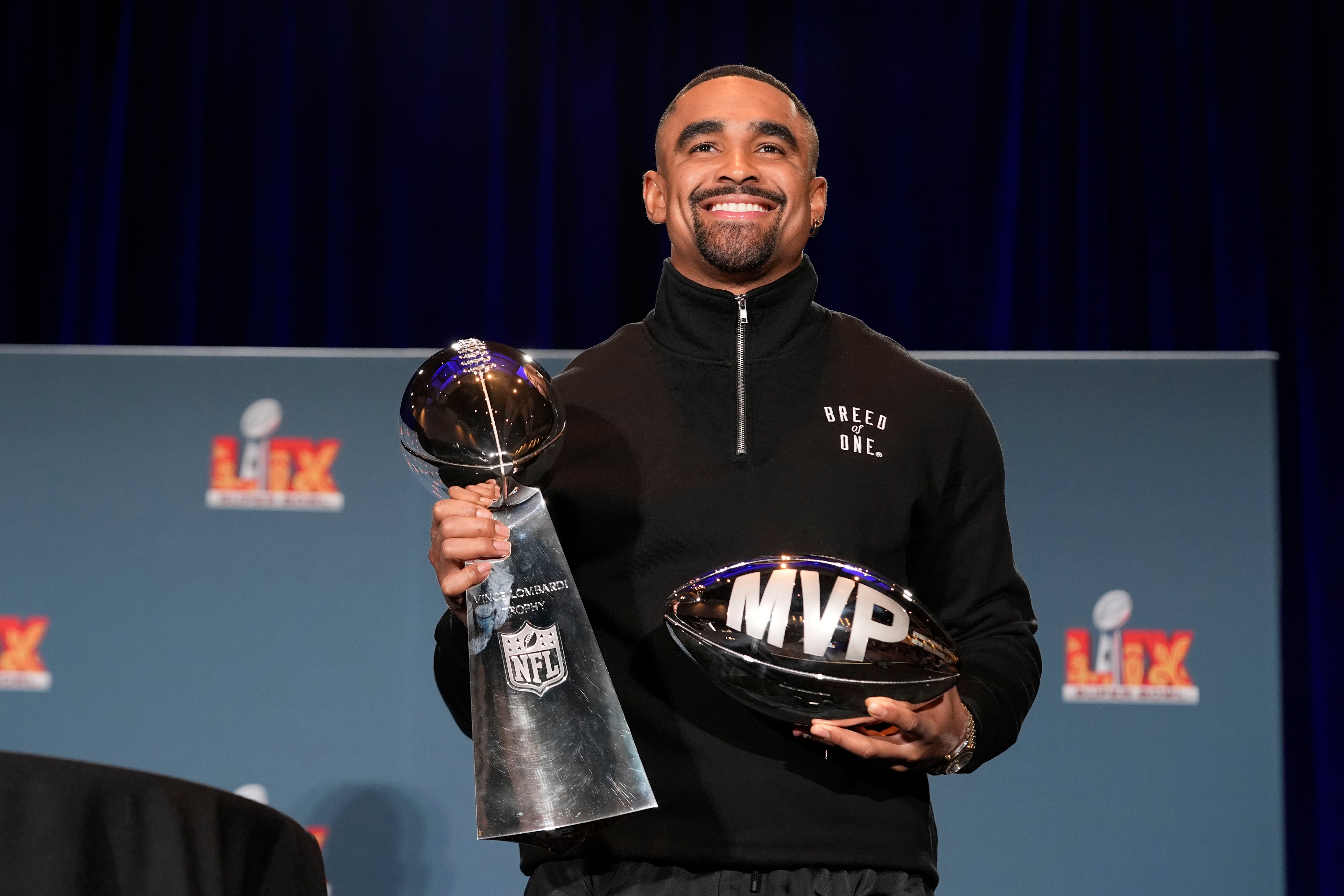 Jalen Hurts with the Super Bowl and MVP trophies