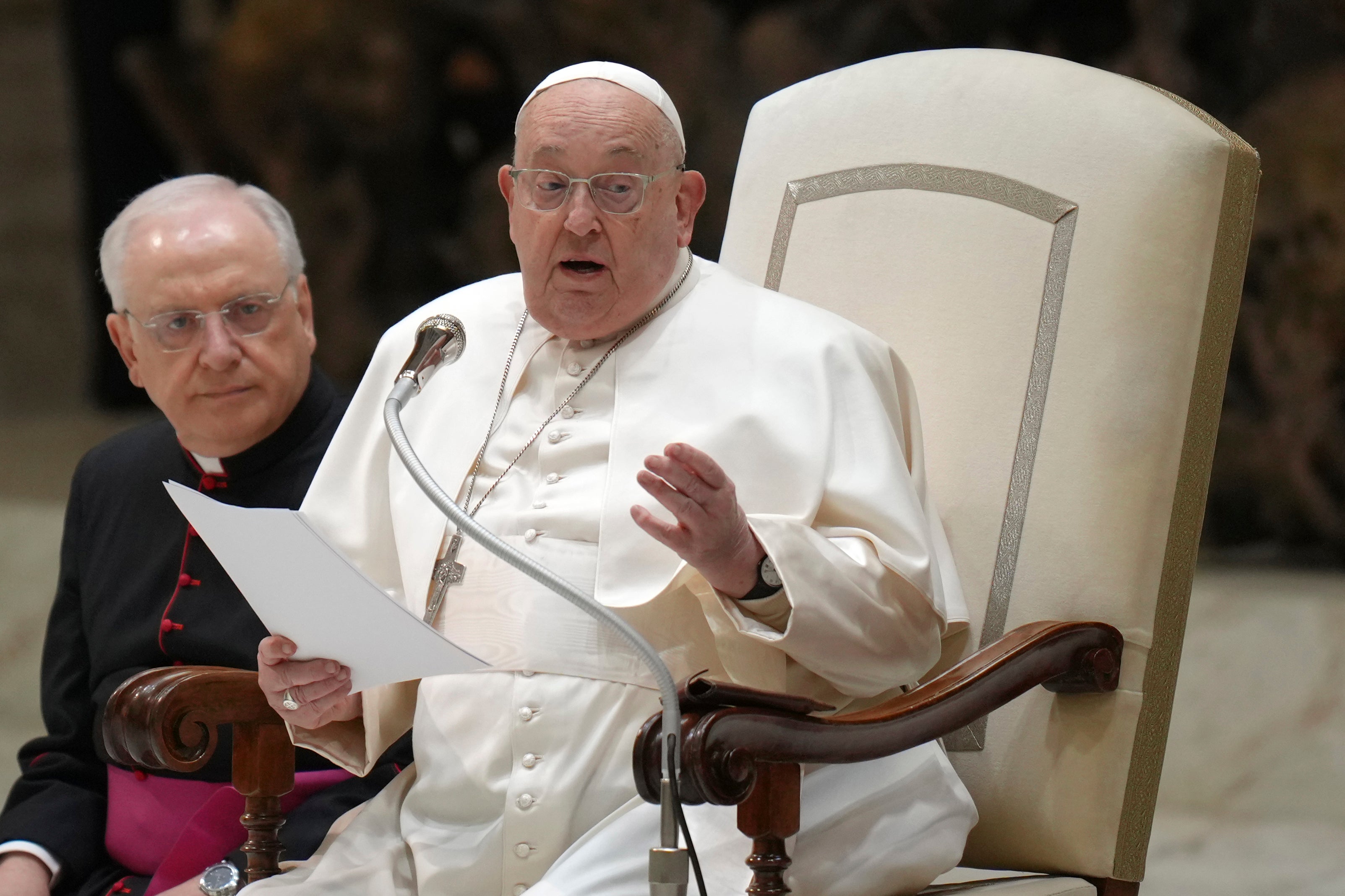 Pope Francis reads his speech during an audience at the Vatican on 12 February 2025