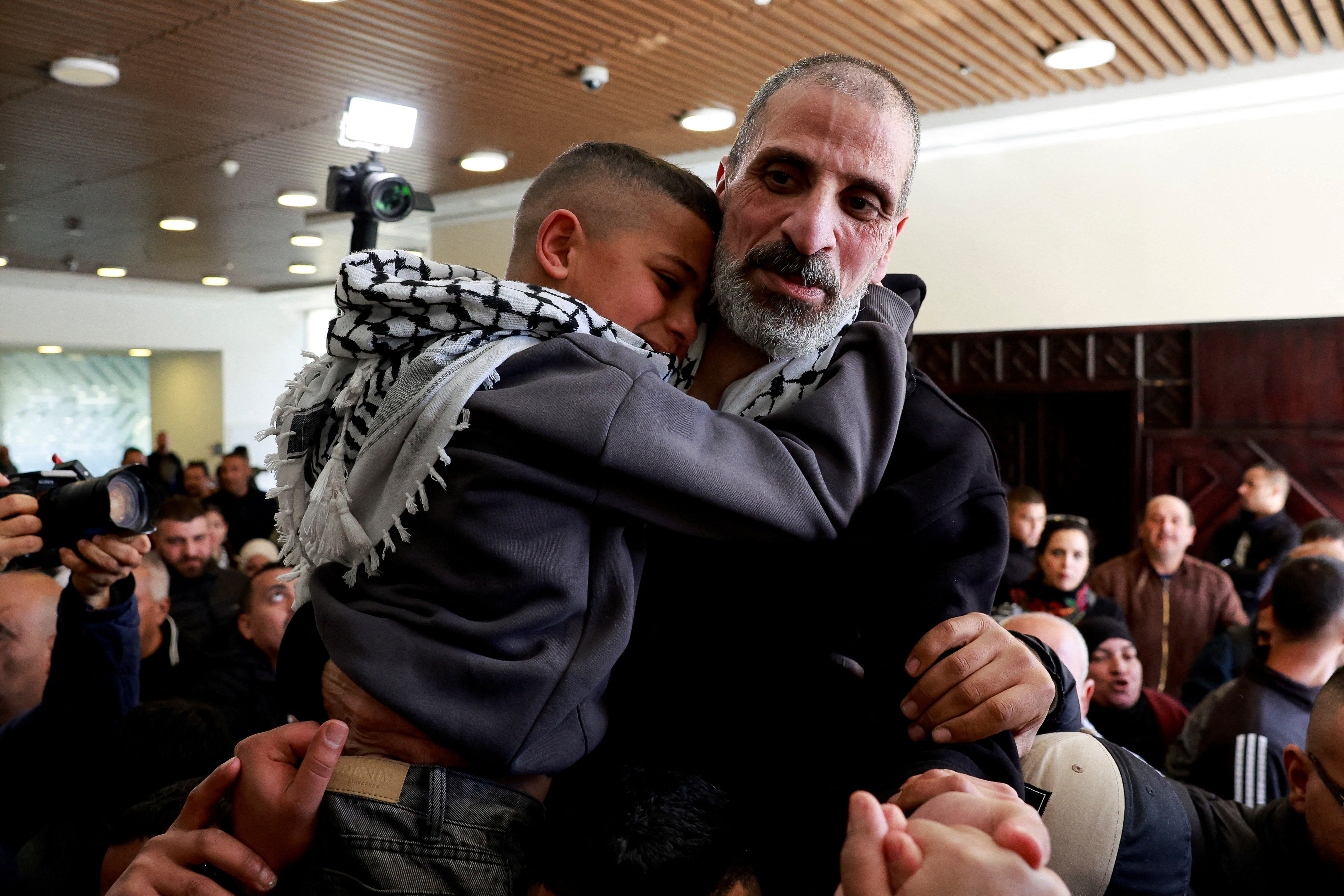 Amir Abu Radha, a freed Palestinian prisoner, is embraced after being released from an Israeli jail