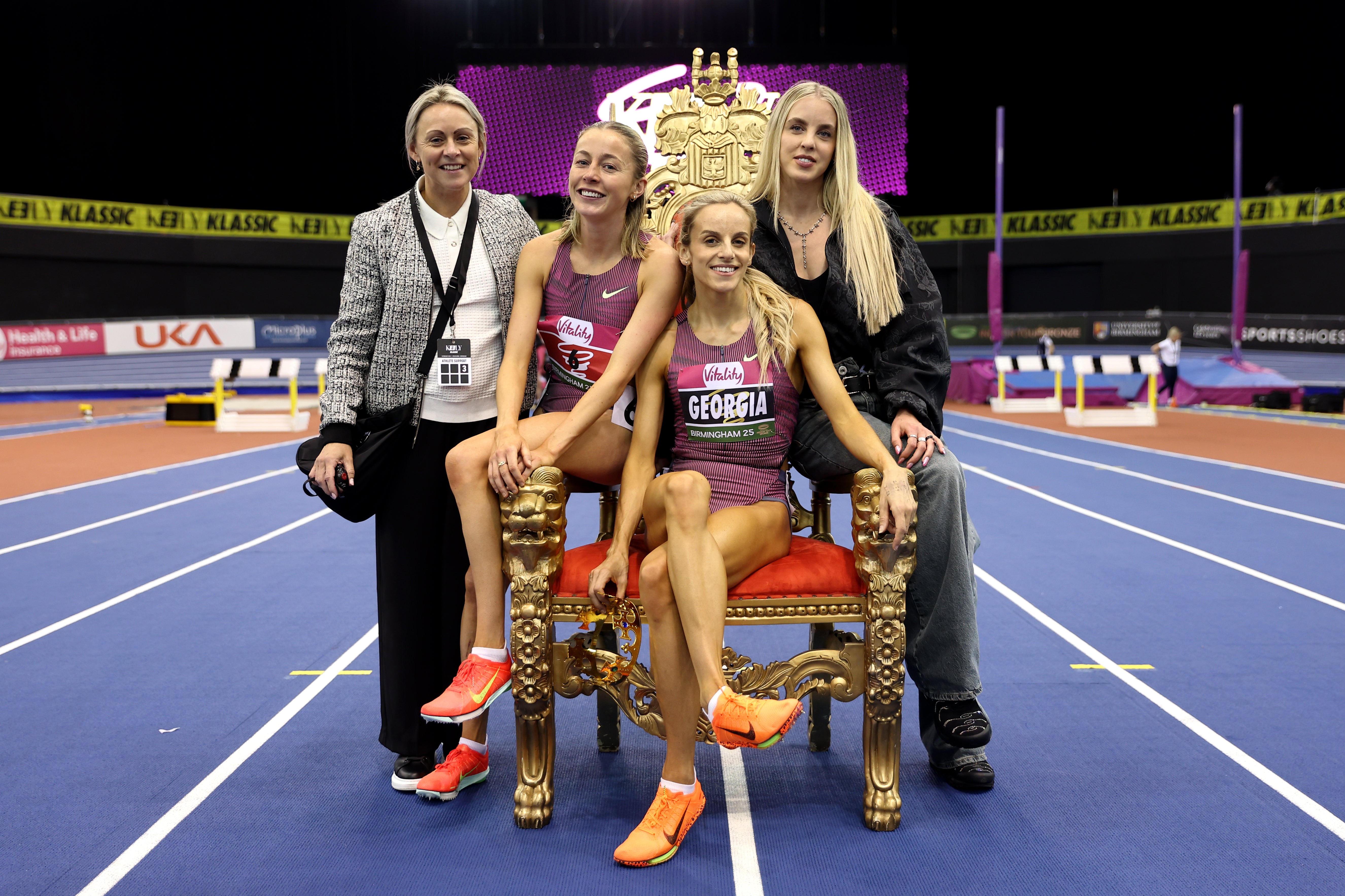 Georgia Hunter Bell sits on the throne as she celebrates victory in the women’s 1,500m with host Keely Hodgkinson, Sarah Healy and coach Jenny Meadows