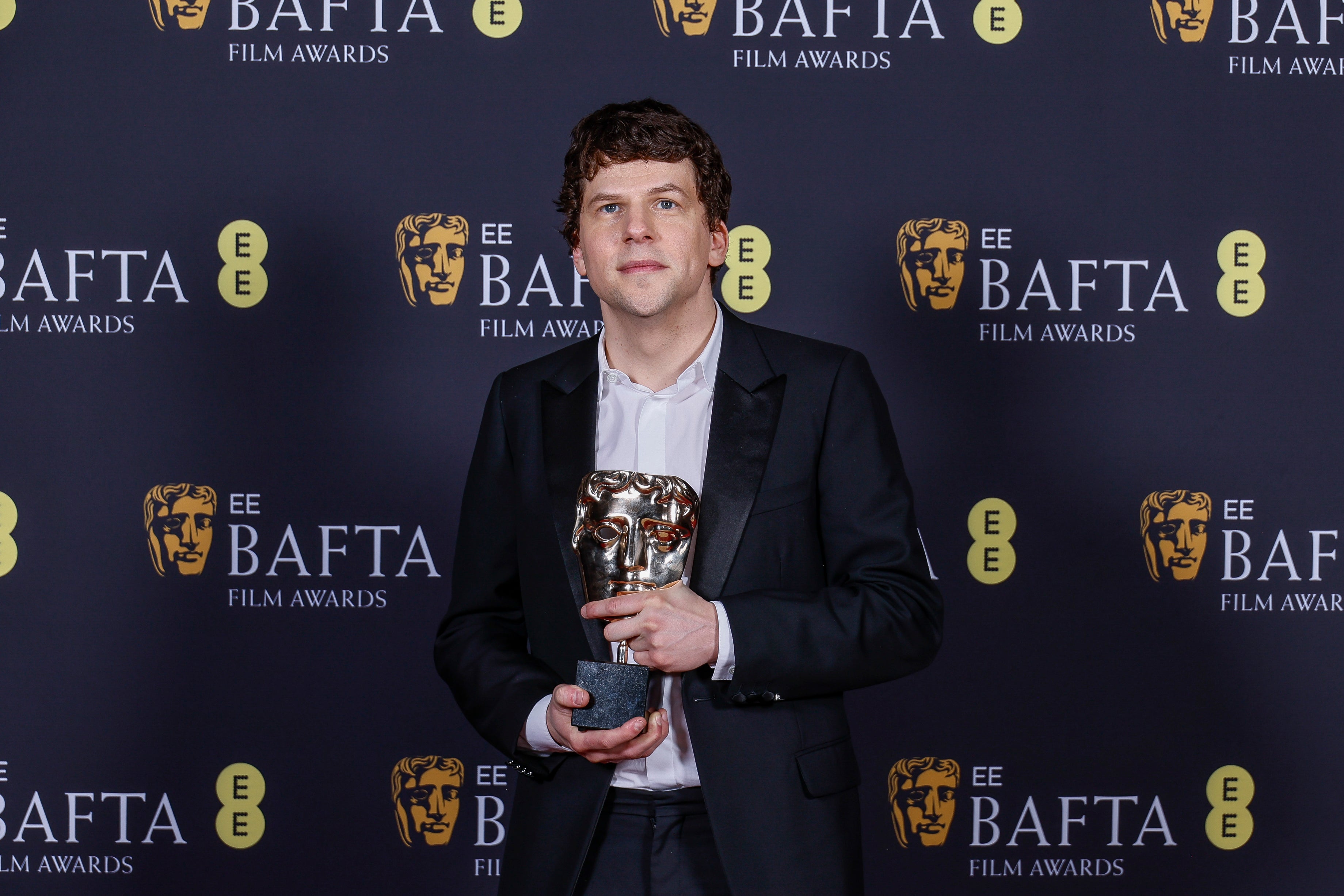Jesse Eisenberg at the Baftas with the award he accepted on behalf of Kieran Culkin for ‘A Real Pain’