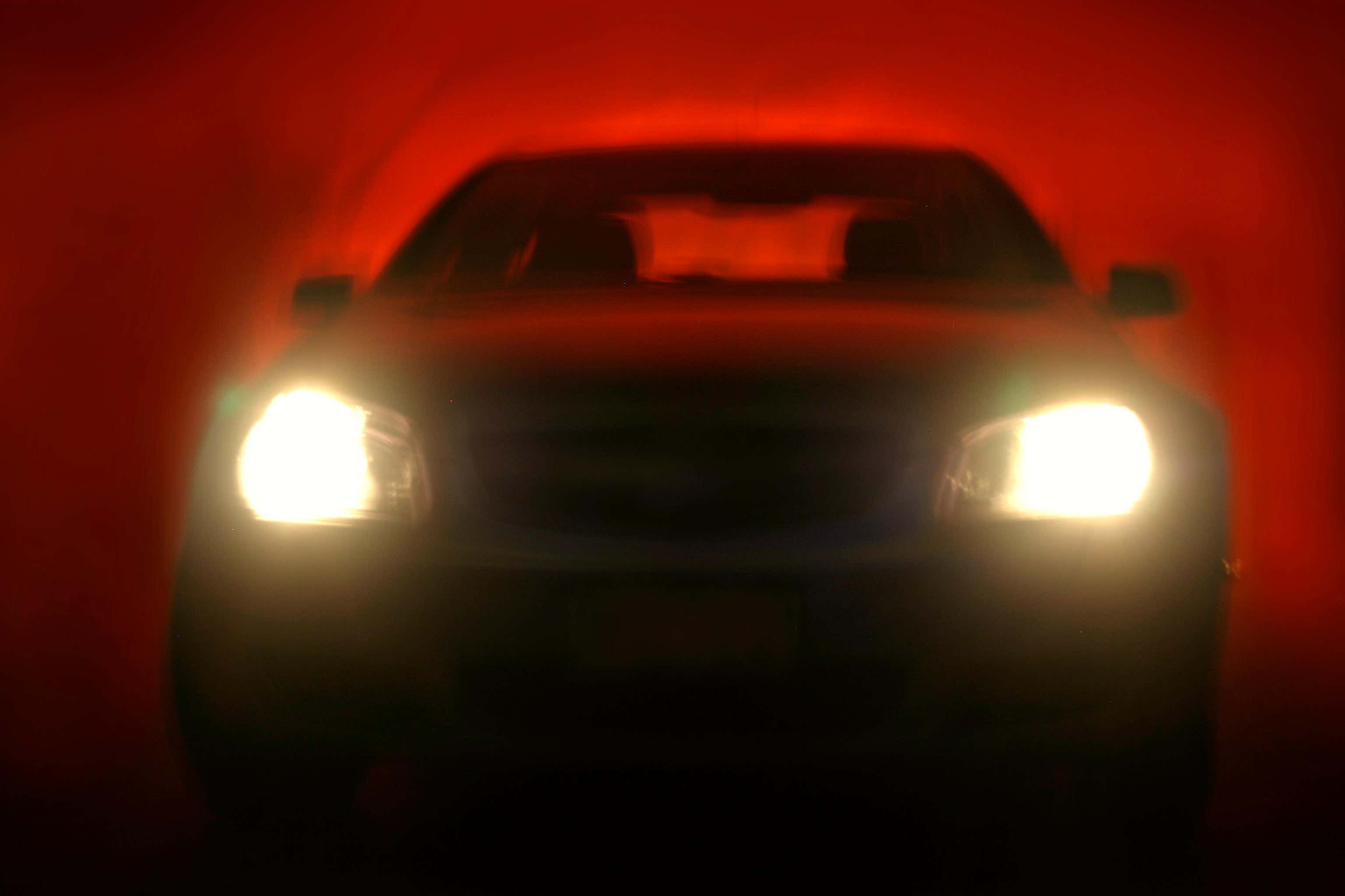 A quarter of drivers who find vehicle headlights too bright are driving less at night because of the issue, a new survey suggests (Alamy/PA)