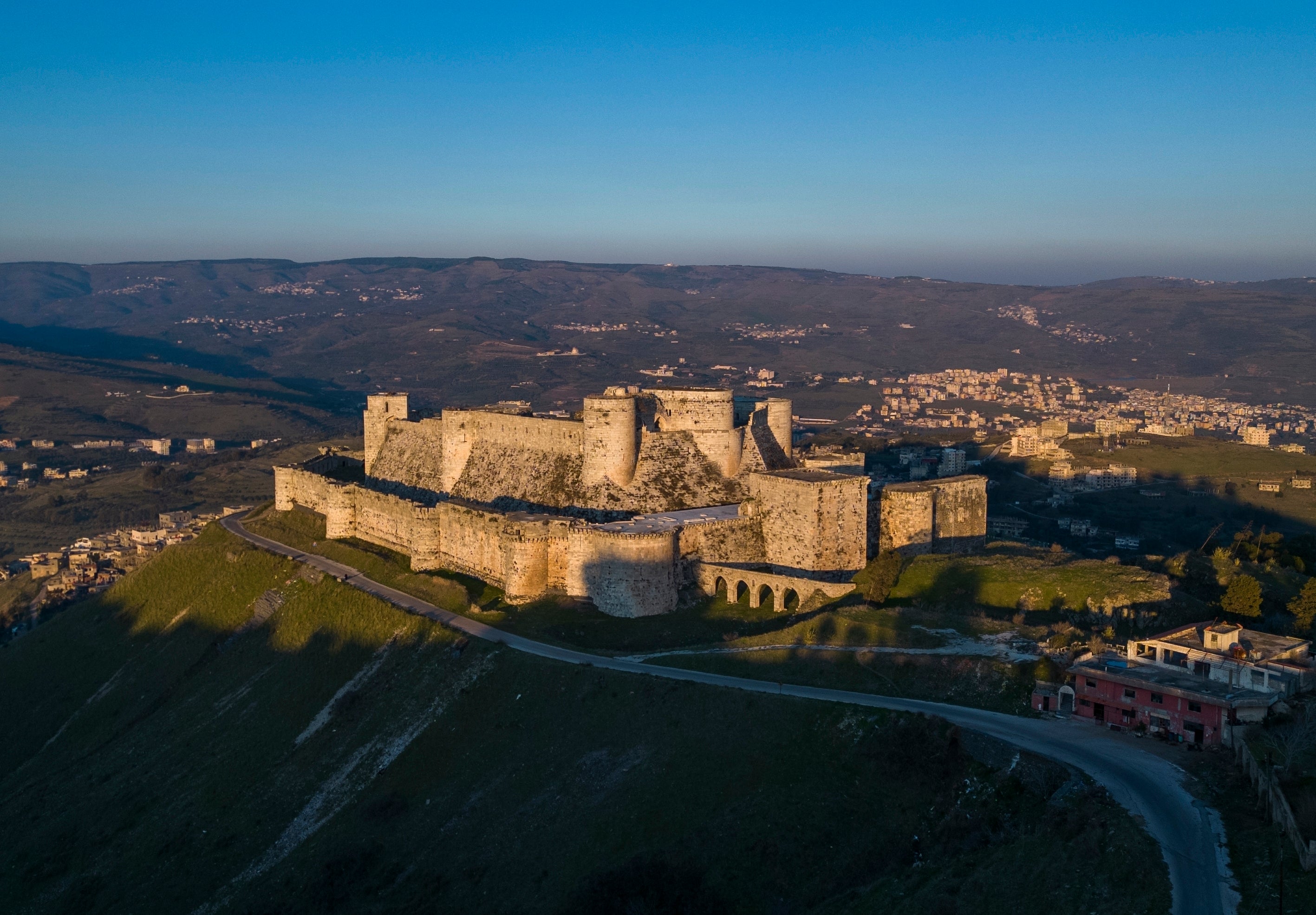 An aerial view shows the sun sets over Krak des Chevaliers on the outskirts of Homs, Syria,