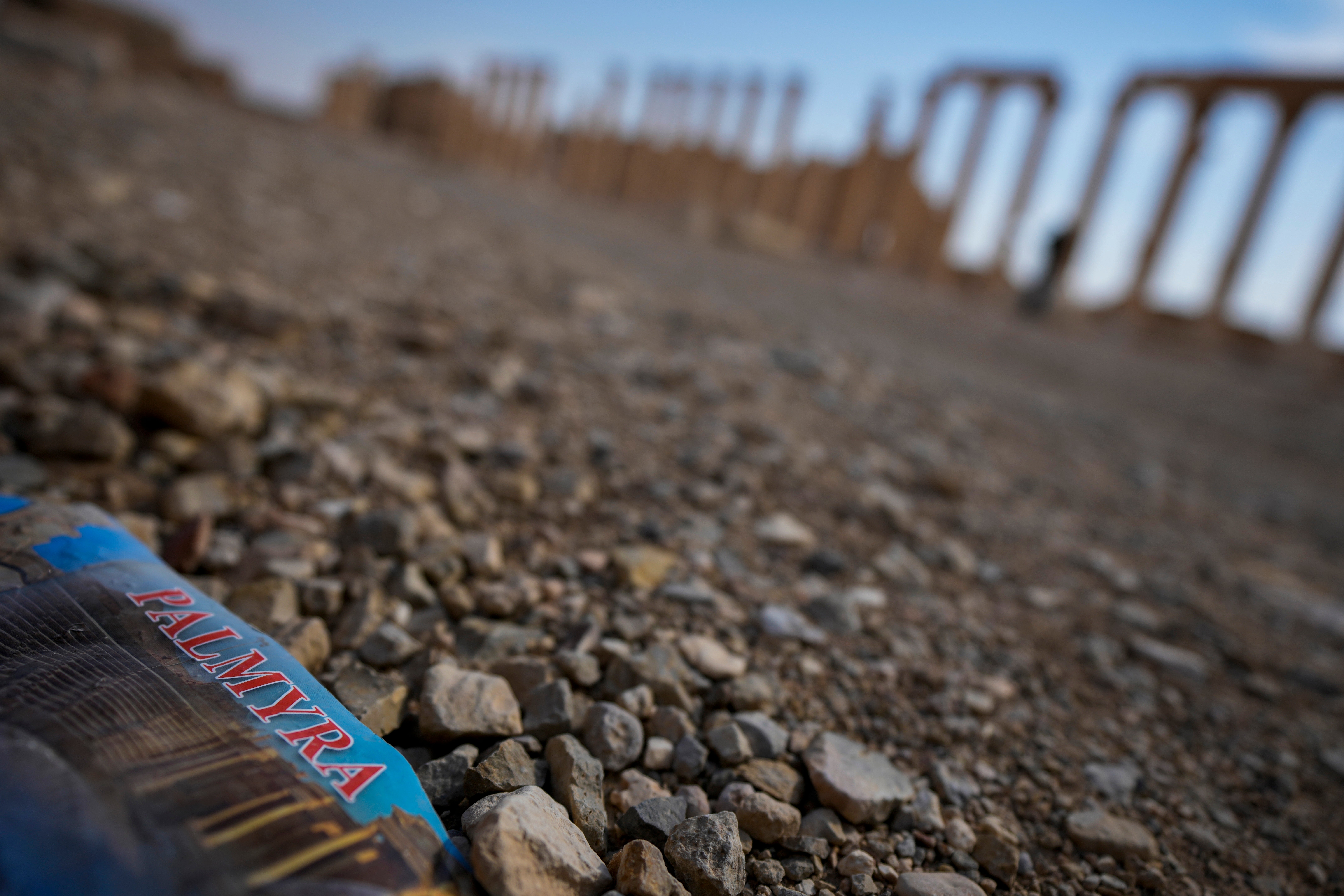 A flyer bearing the name ‘Palmyra’ lies on the ground in the ancient city of Palmyra, Syria