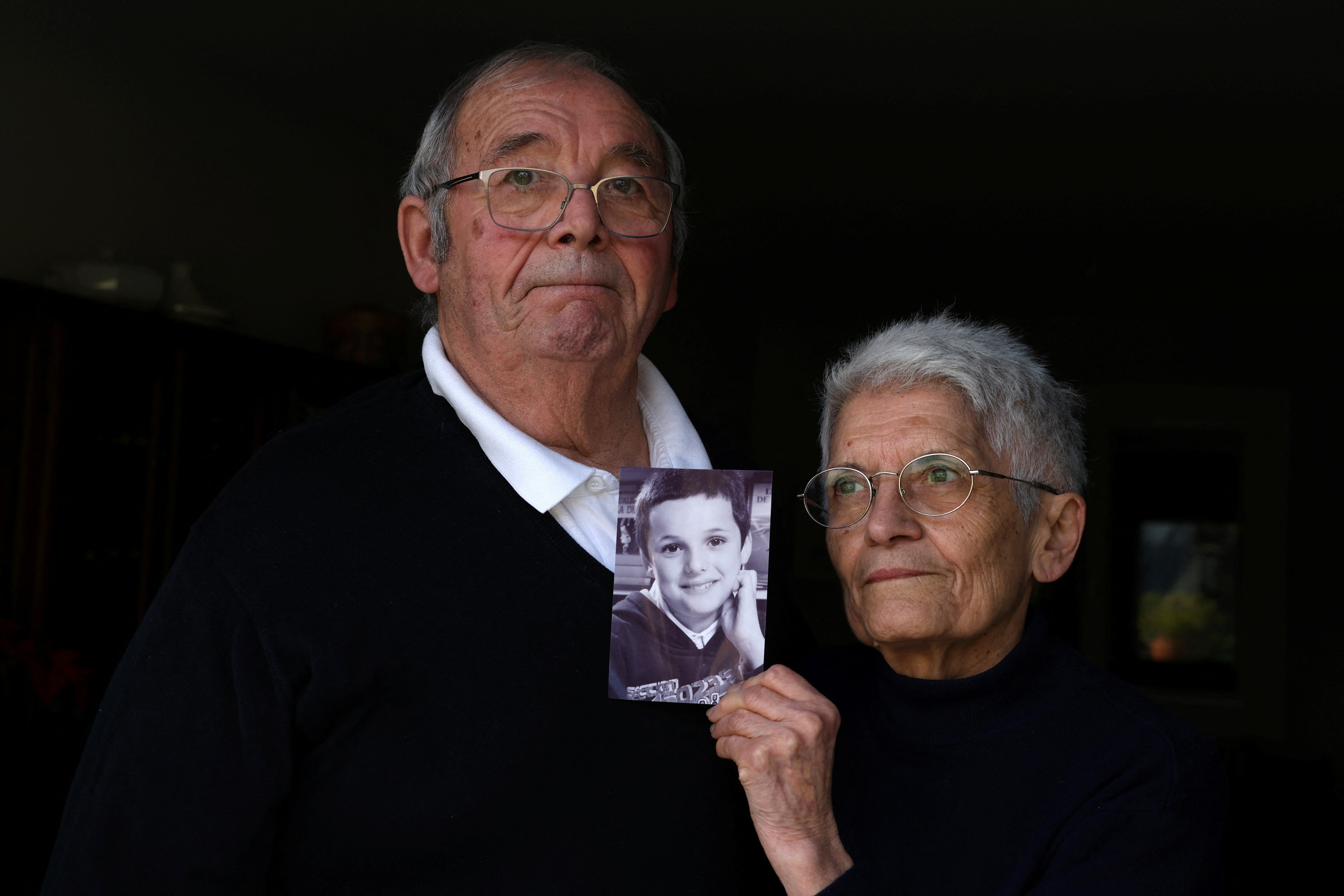 Roland and Mauricette Vinet hold a photo of their grandson Mathis Vinet at their home in Saint-Germain near Poitiers, before the opening of the trial in Vannes of French ex-surgeon Joel Le Scouarnec, accused of the aggravated rape and sexual assault against hundreds of children during three decades, France, February 5, 2025