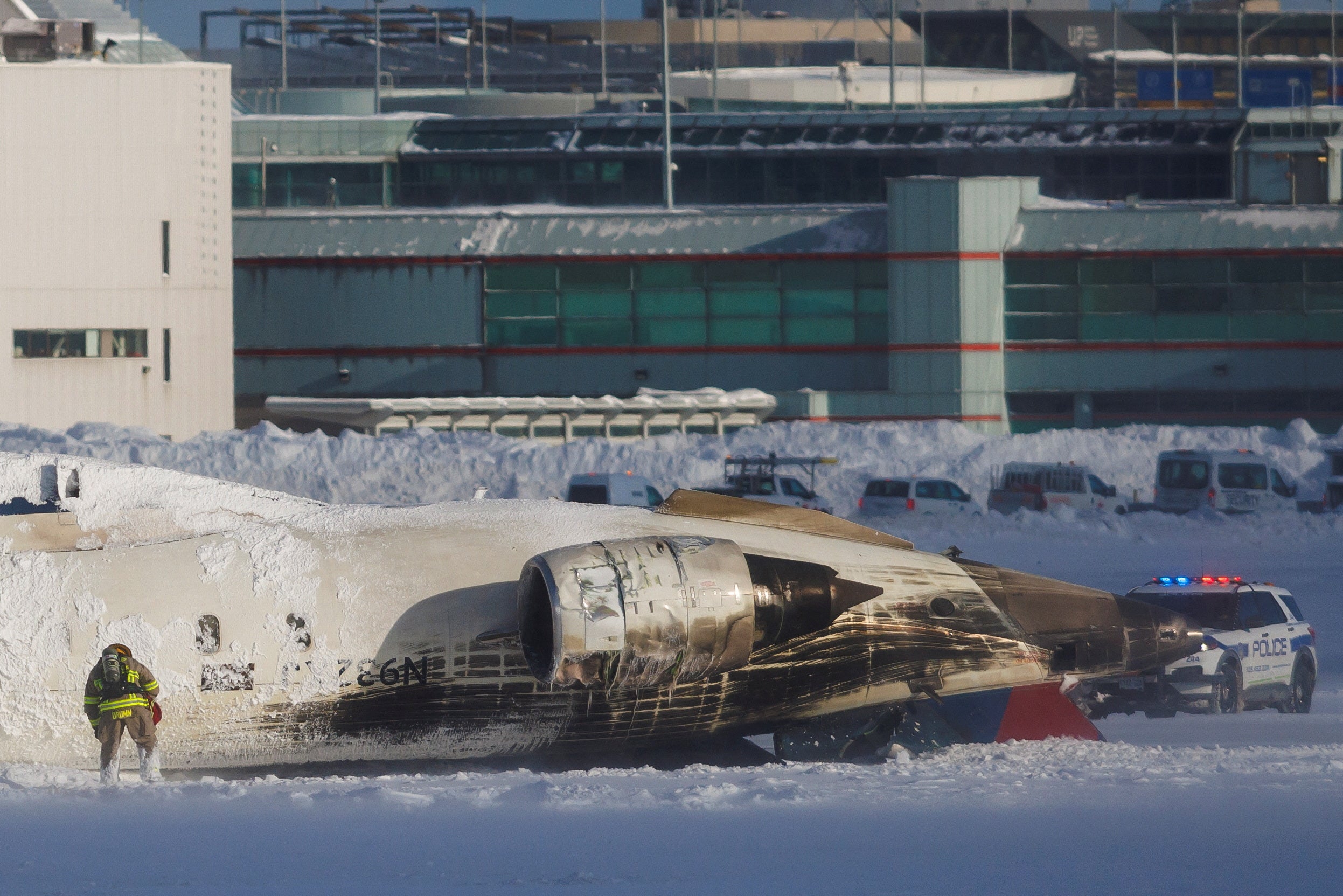 An emergency responder works around the aircraft