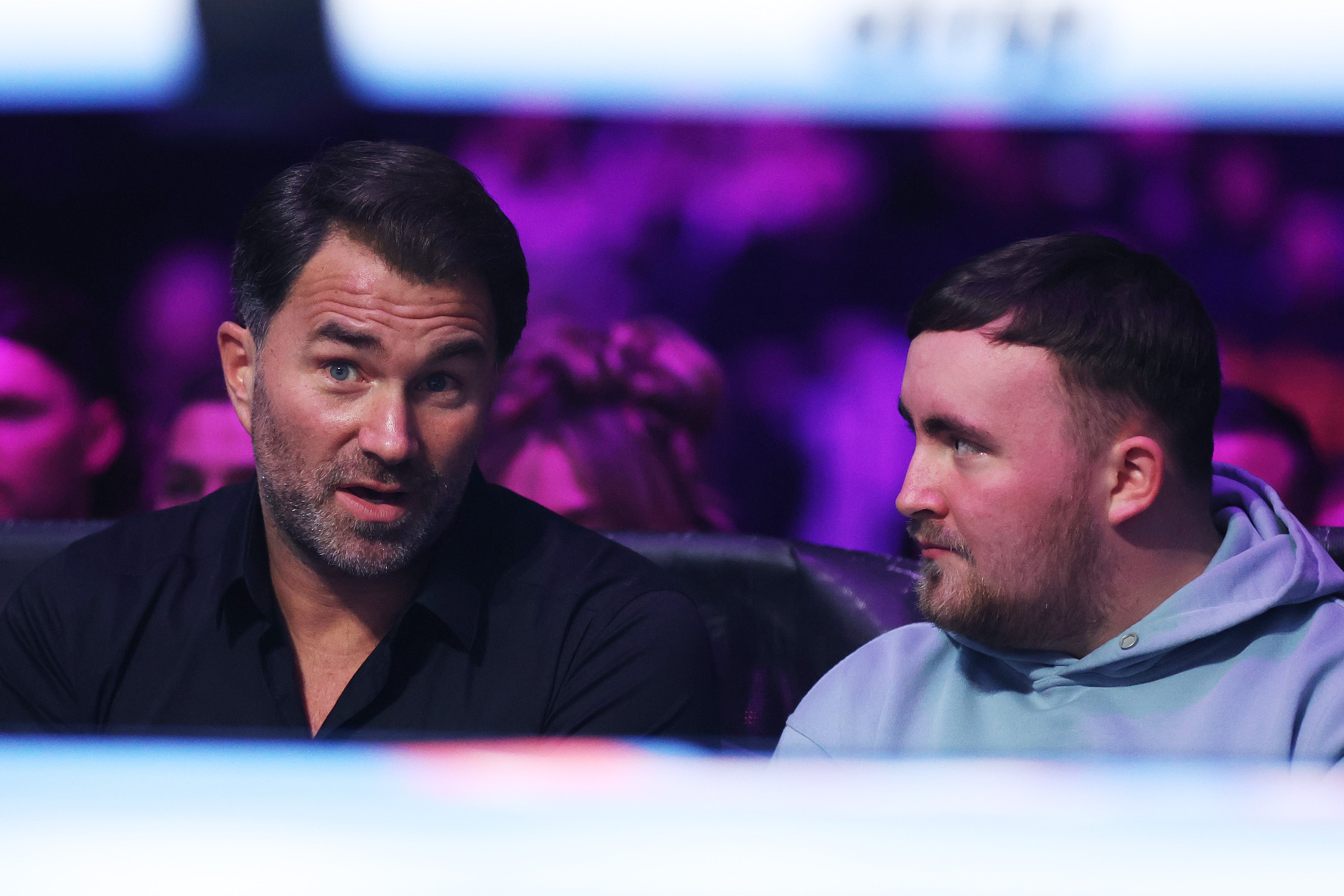 Catterall's promoter Eddie Hearn (left) sitting ringside with teenage darts star Luke Littler