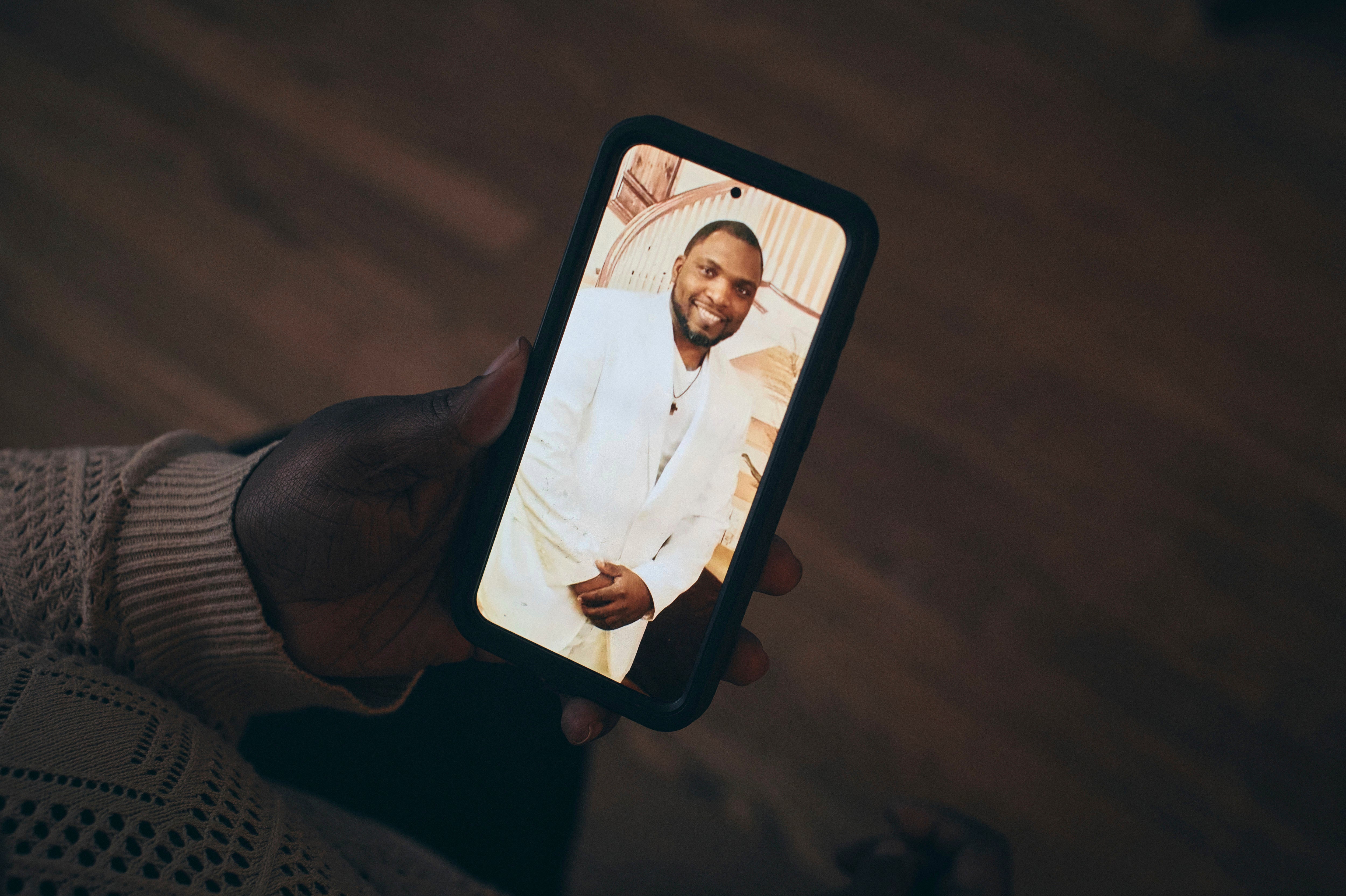 Sharline Volcy shows a picture of her husband, Ronald Donat
