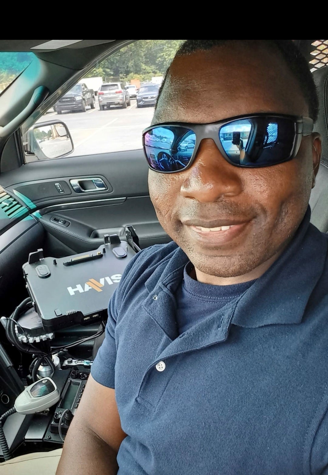 In this photo provided by Sharline Volcy, Ronald Donat poses for a selfie in a squad car