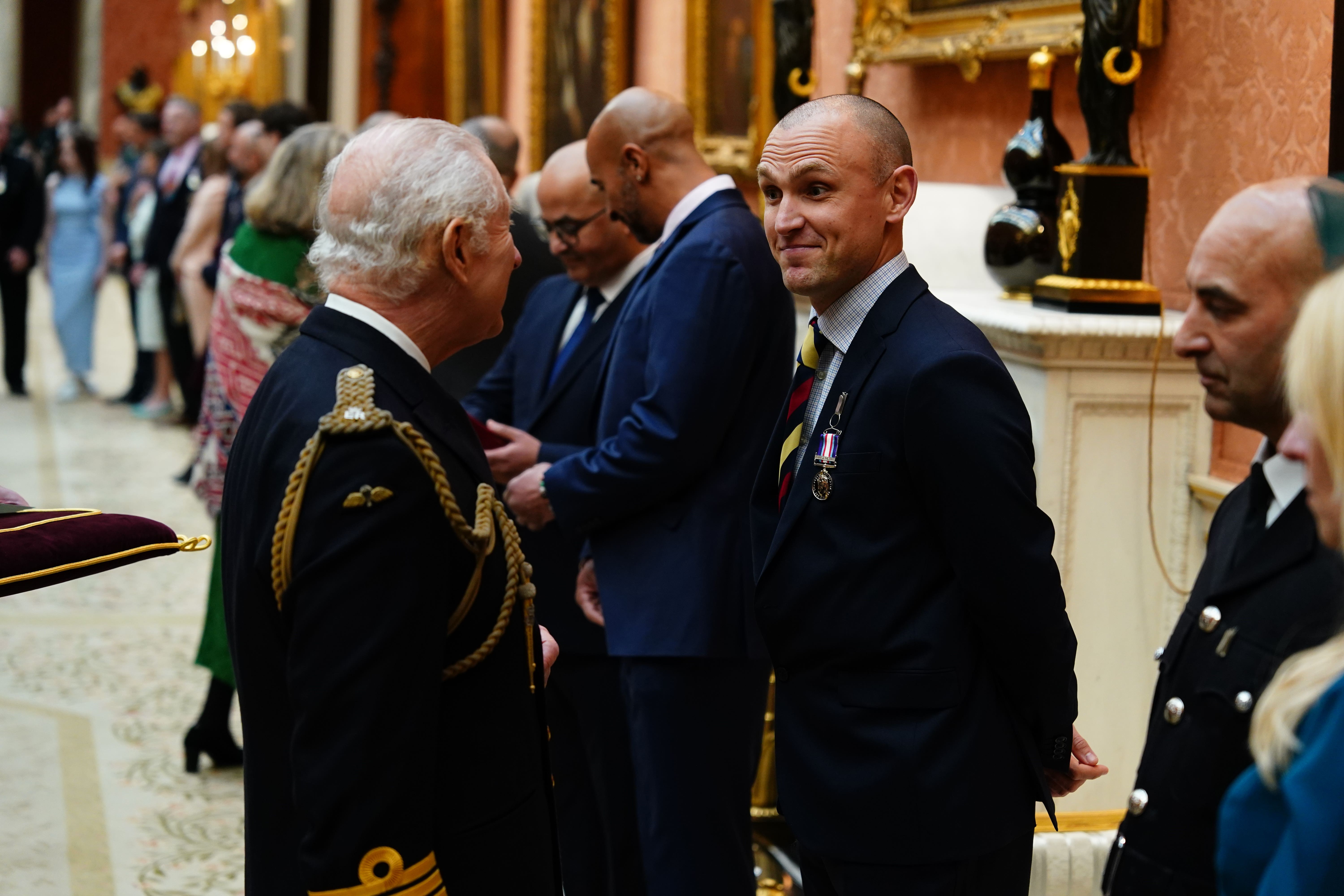 The King presents the Humanitarian Medal to Matthew Newport at Buckingham Palace (Jordan Pettitt/PA)