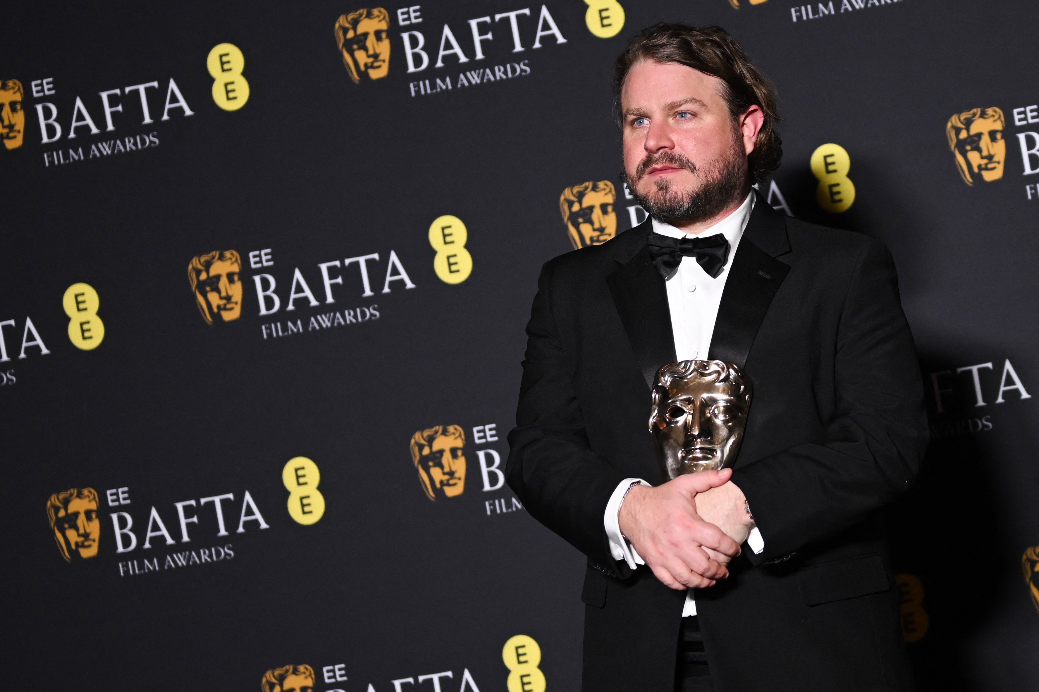 Brady Corbet with the award for Best director for The Brutalist at the BAFTA ceremony