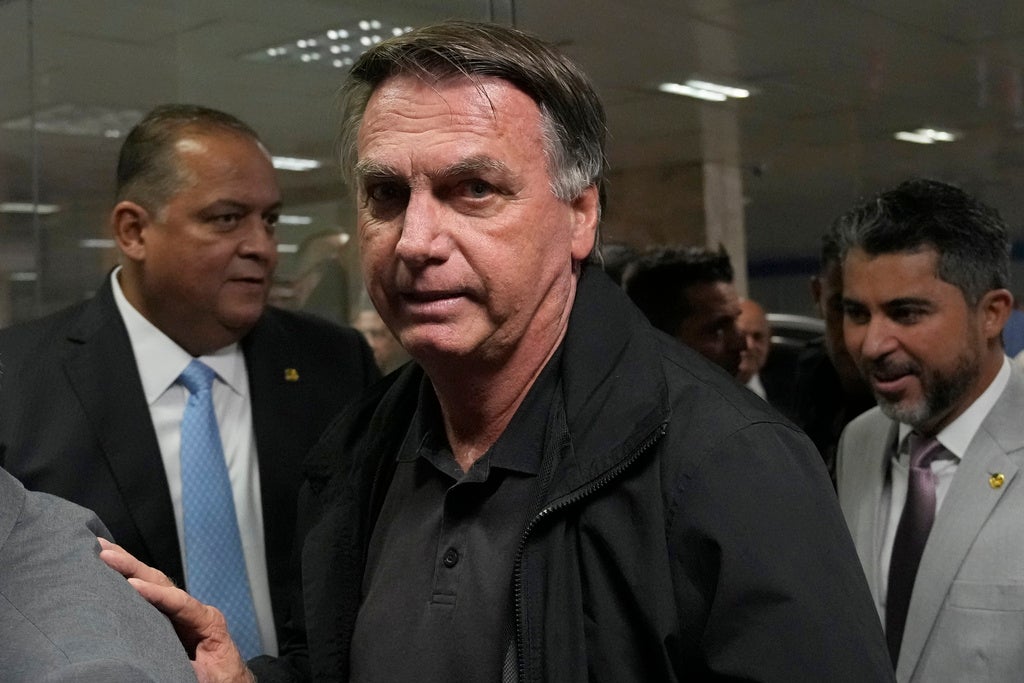 Former Brazilian President Jair Bolsonaro arrives for a luncheon with senators from his support base, at the National Congress building in Brasilia, Brazil, Tuesday, Feb. 18, 2025
