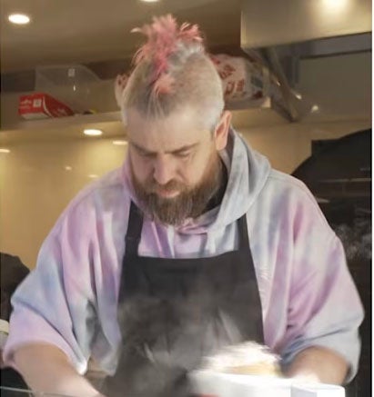 Spudman serving his customers hot spuds