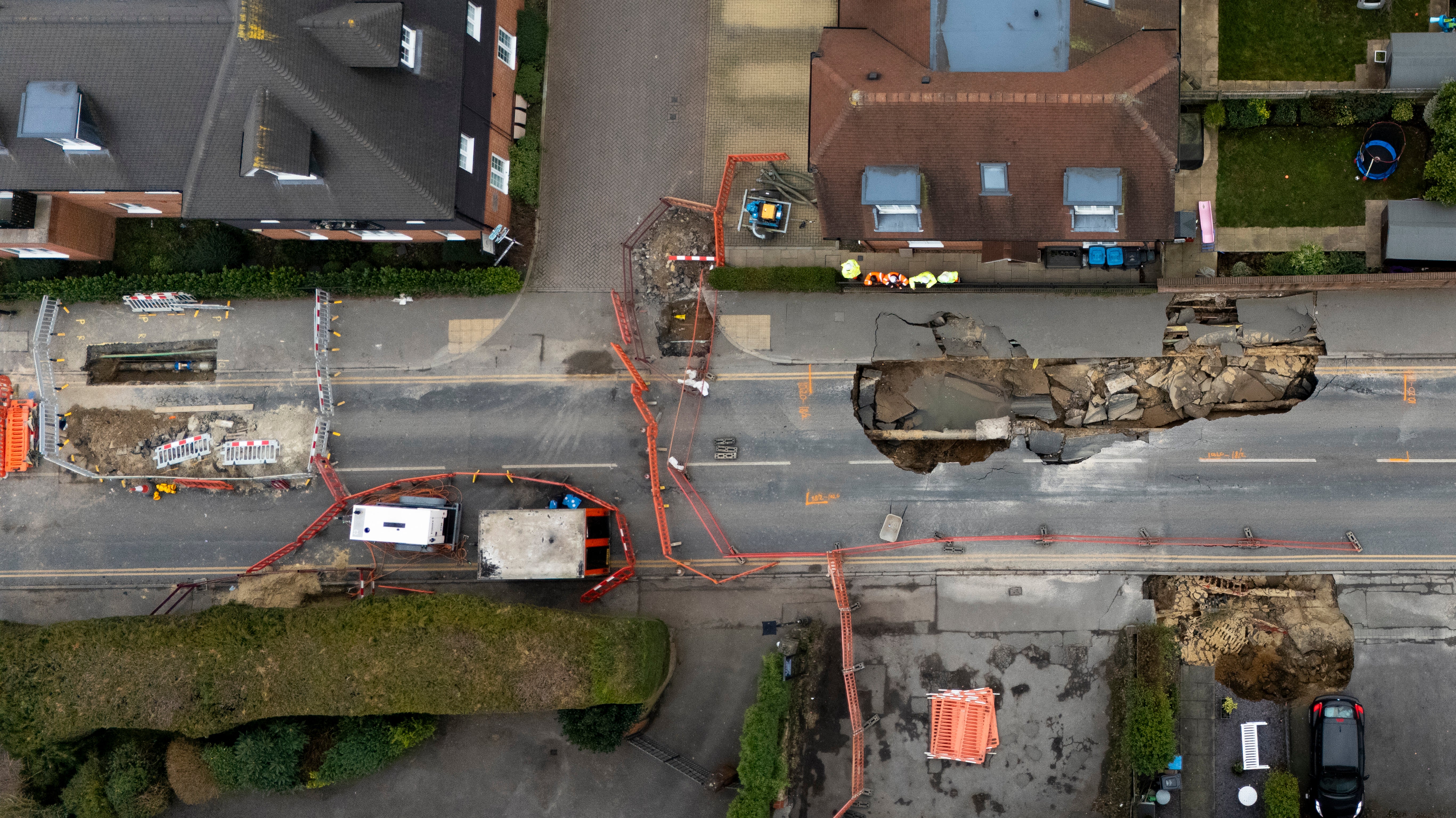 Residents of a quiet Surrey village of Godstone were told to “get out as quickly as possible” as a huge crater swallowed a street overnight on February 17.