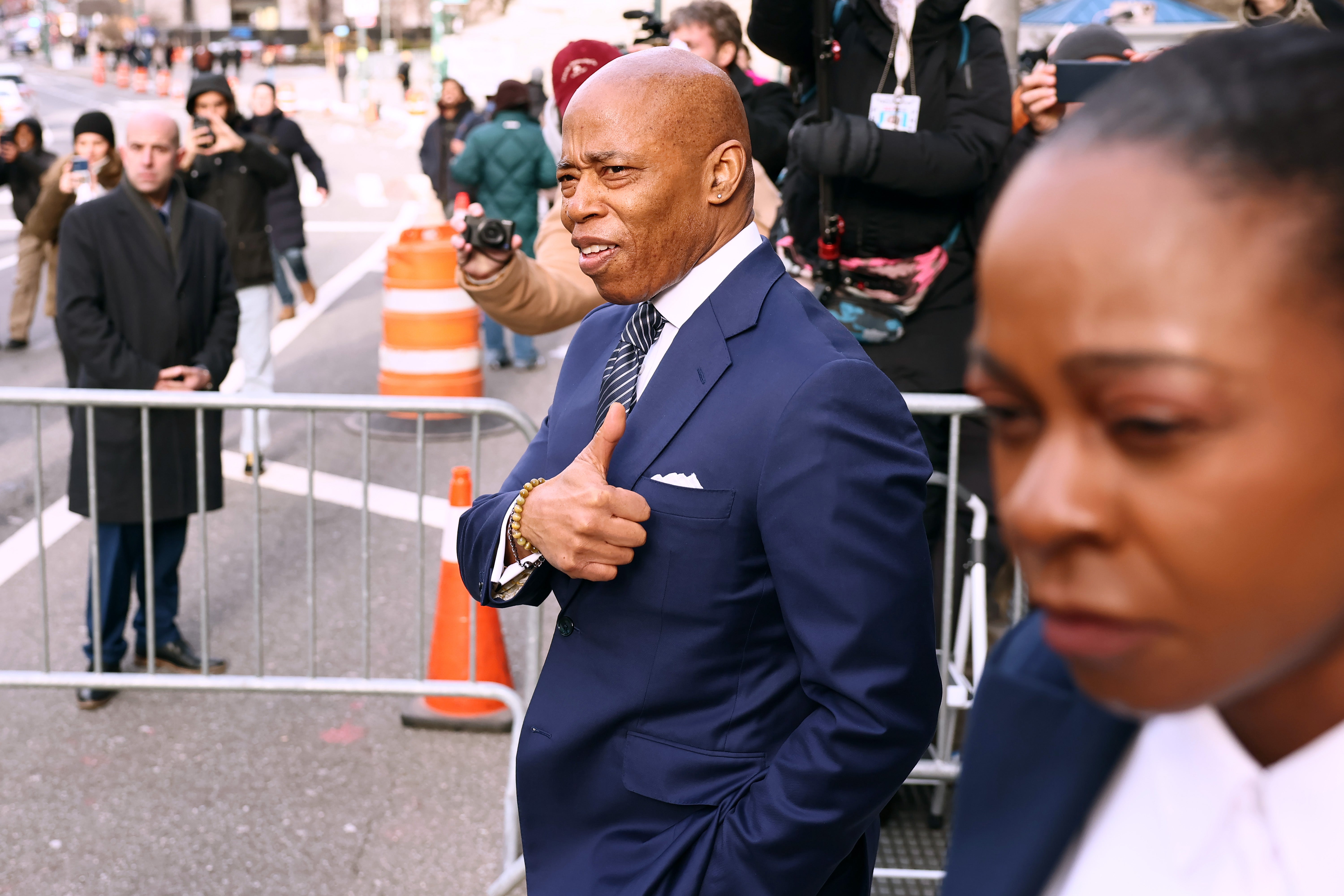 Adams flashes a thumbs up to the media as he walks into court without hearing whether the judge would agree to drop his case