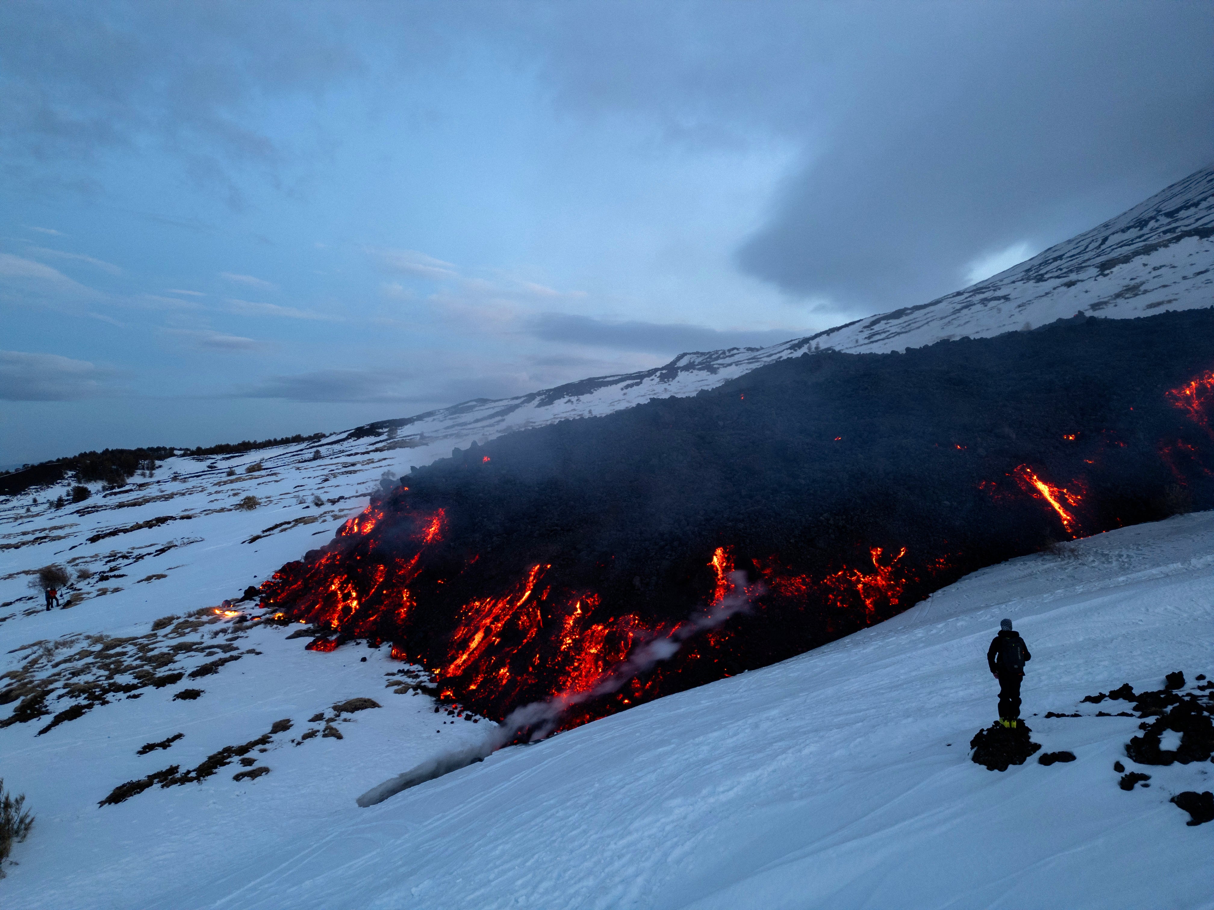 Sprays of lava have flowed onto the snow from the Bocca Nuova crater