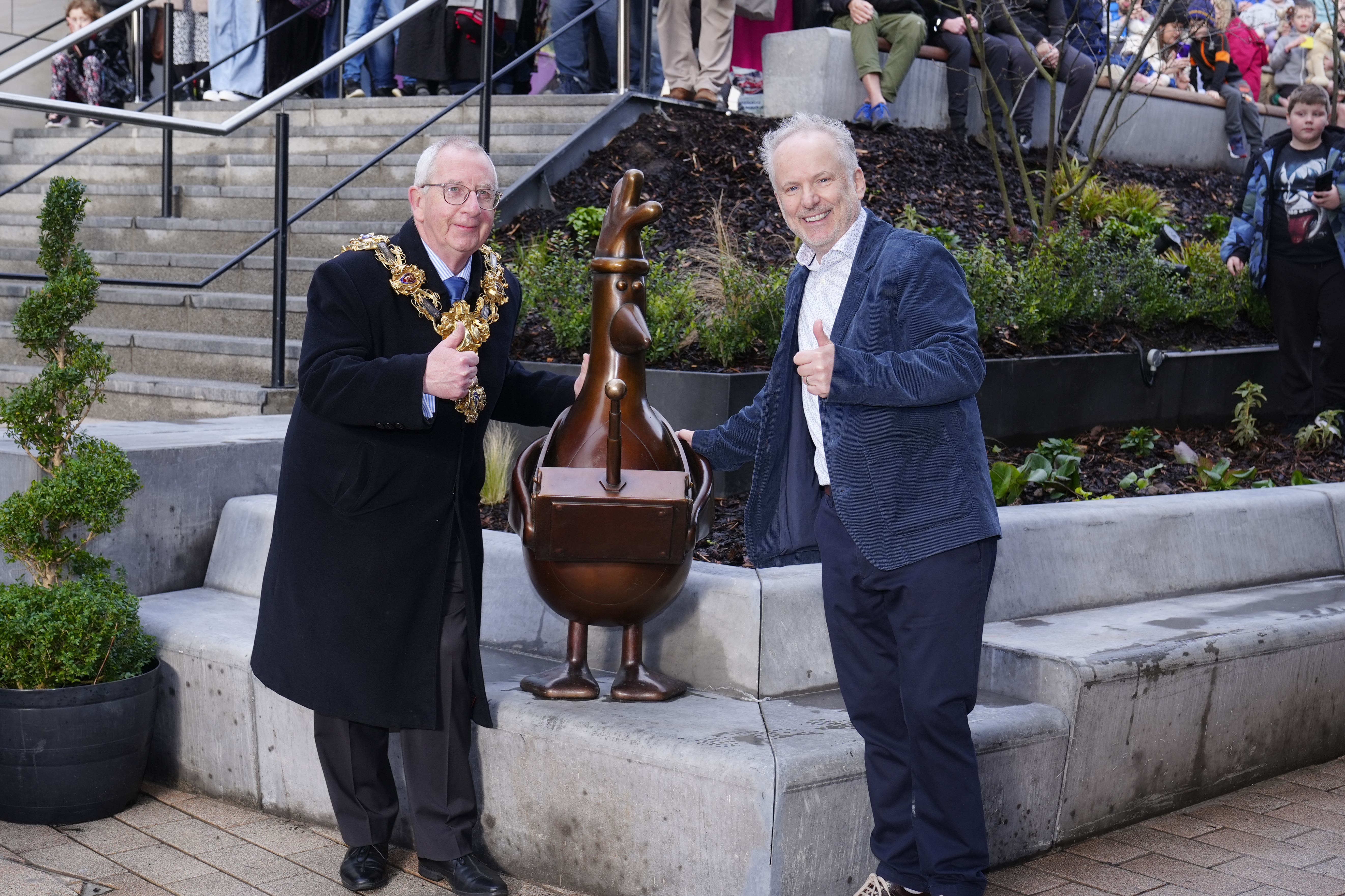 Wallace and Gromit creator Nick Park and the Mayor of Preston, Councillor Philip Crowe, pose next to the statue of the animated character Feathers McGraw at Animate in Preston (Peter Byrne/PA)
