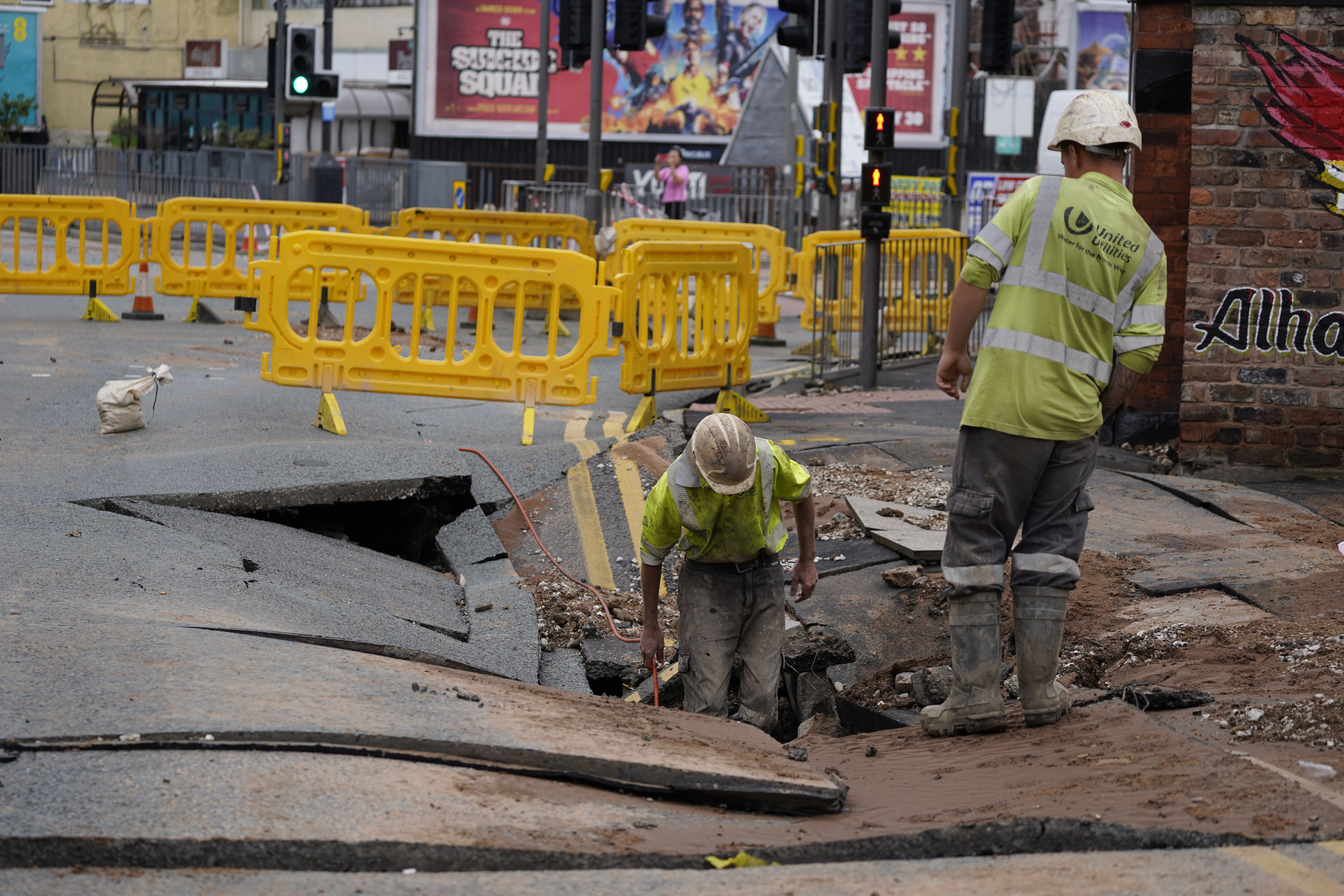 United Utilities workers inspect a sinkhole in Old Swan, Liverpool in 2021 (Peter Byrne/PA)
