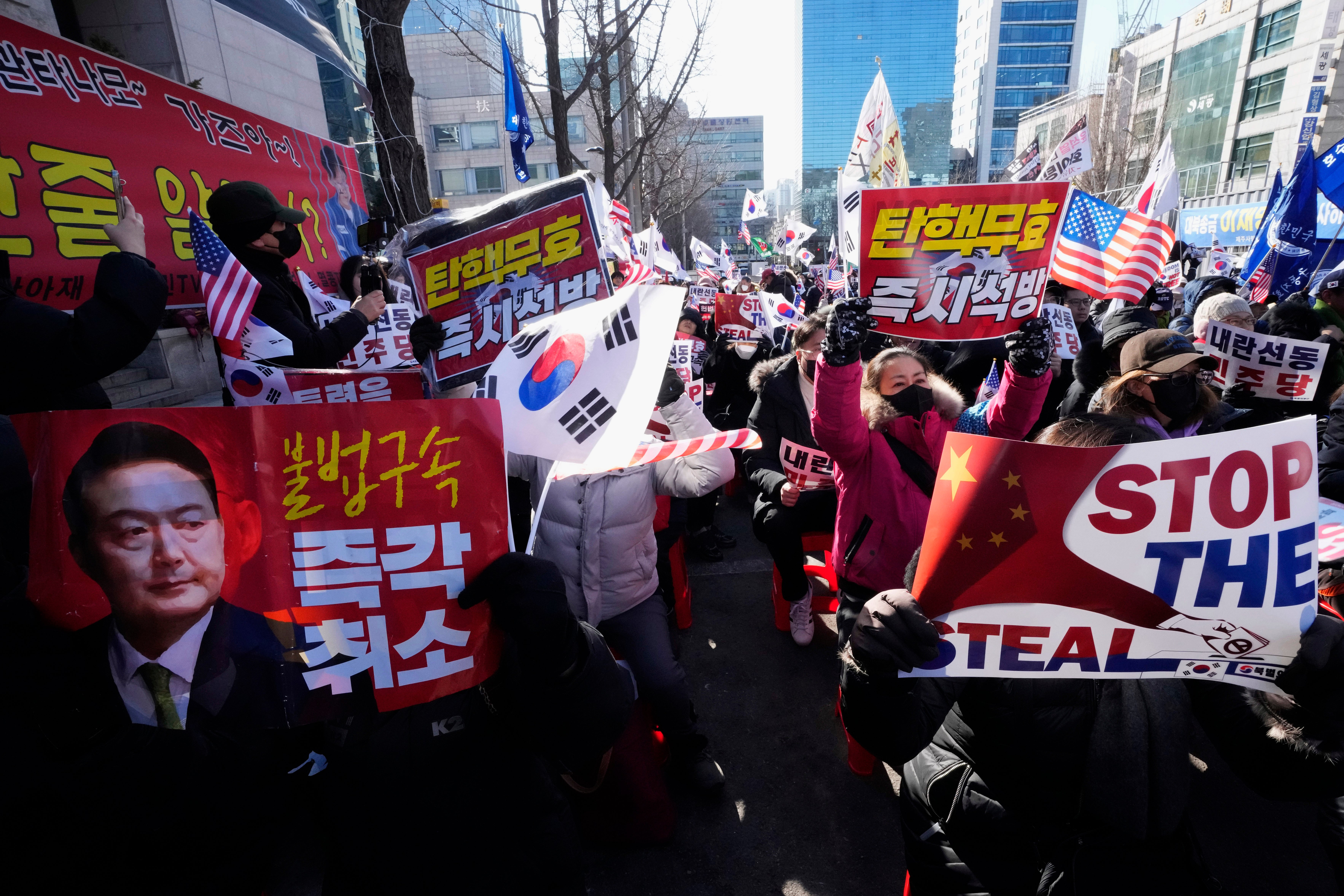 Supporters of impeached South Korean president Yoon Suk Yeol stage a rally to oppose his impeachment near the Seoul Central District Court