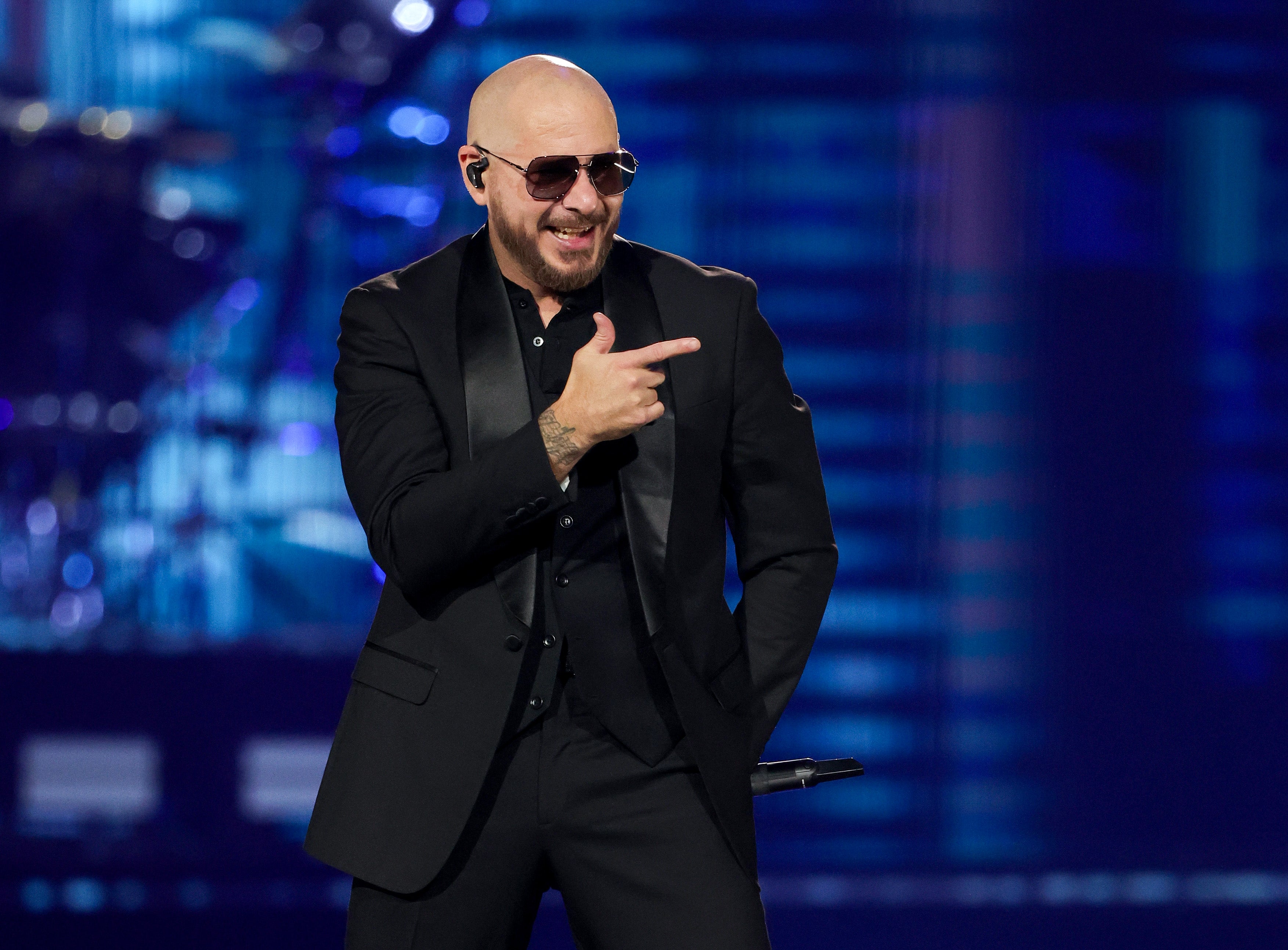 Mr Worldwide: Pitbull performs to a crowd of women in bald caps in November 2024