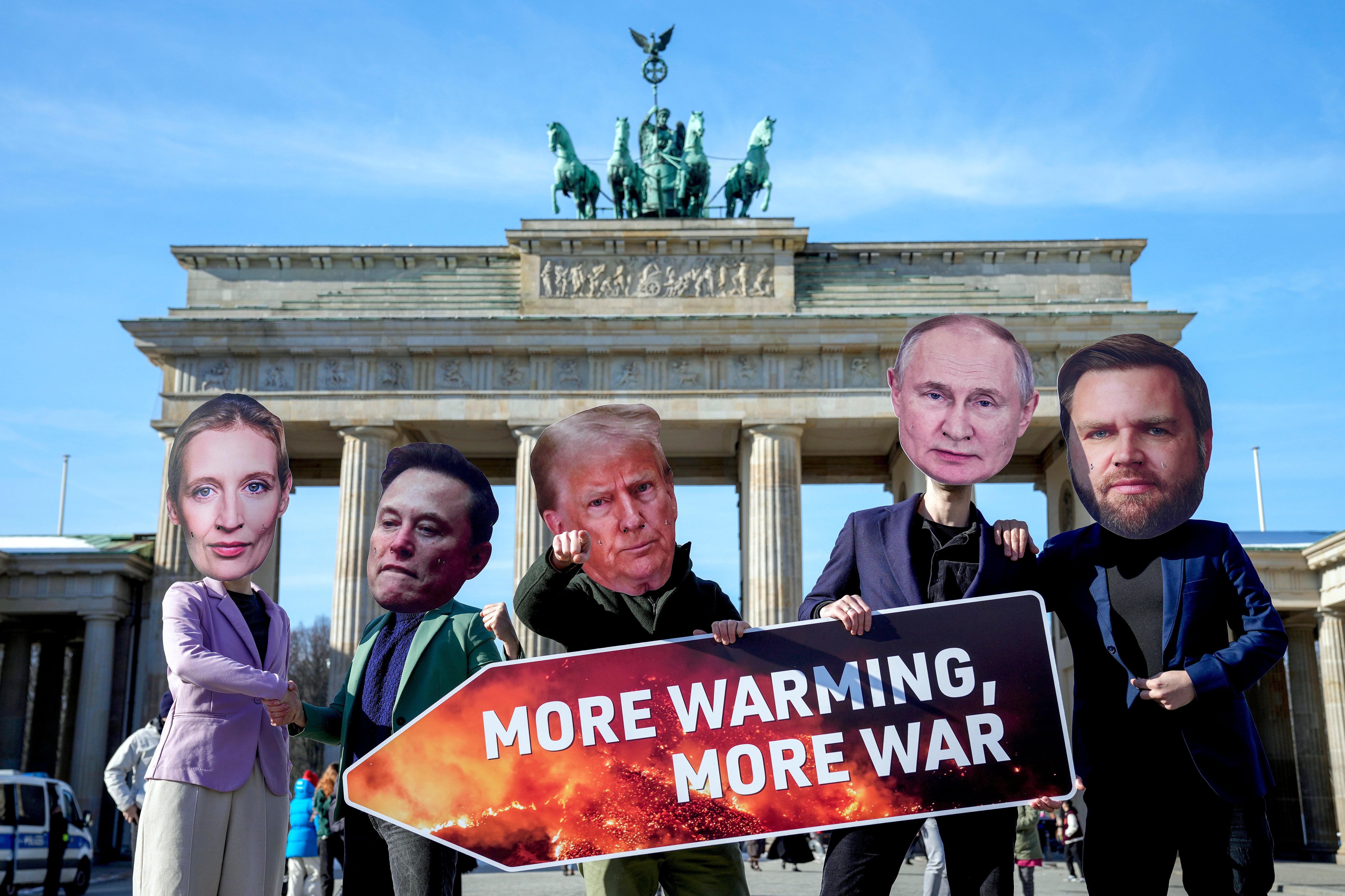 From left, Activists wearing masks of AfD top candidate for Chancellor Alice Weidel, Elon Musk, US President Donald Trump, Russian President Vladimir Putin and US Vice President JD Vance, protest against the support of the US and Russia for the far-right AfD party in front of the Brandenburg Gate in Berlin, Germany