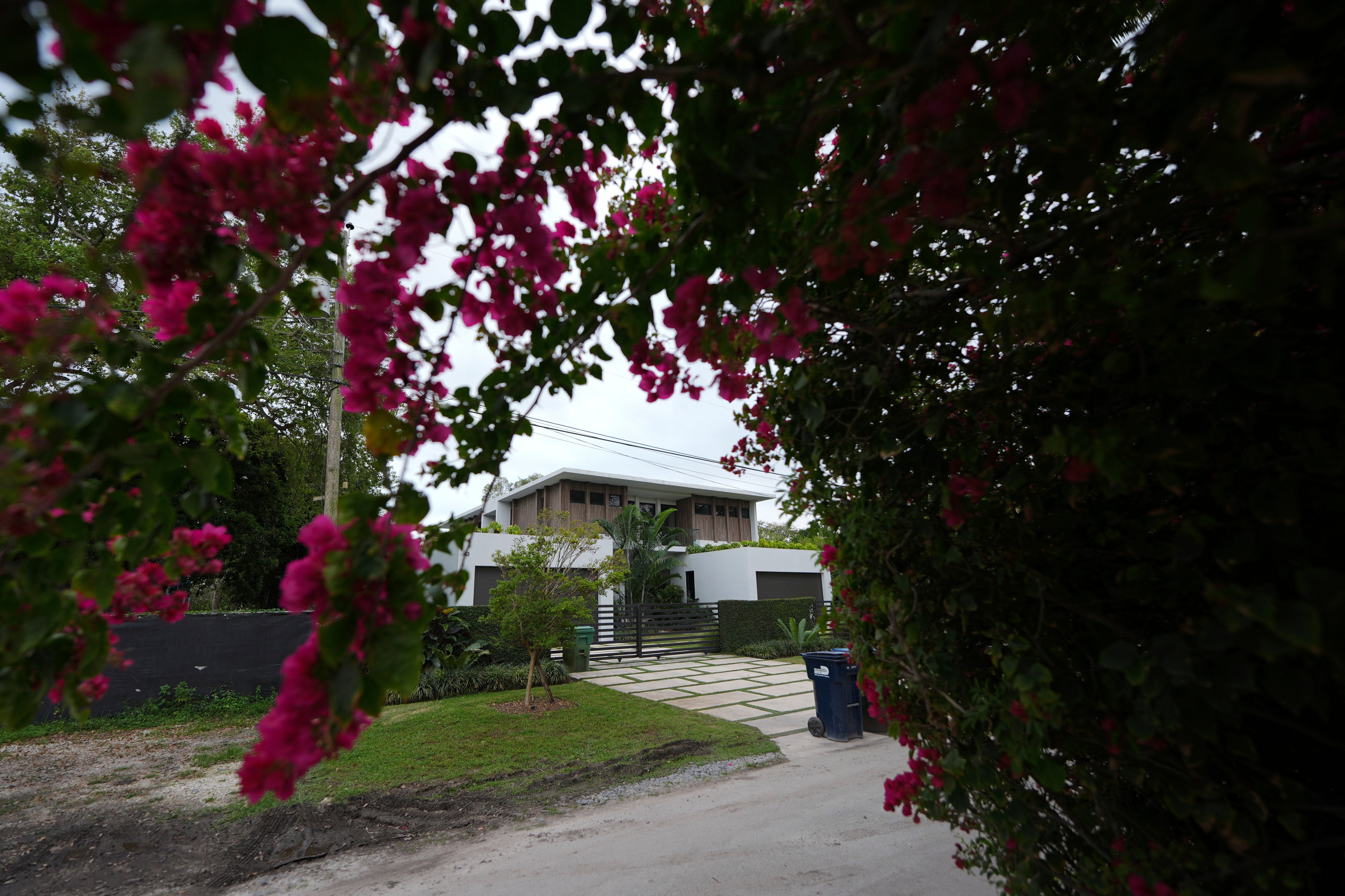 Flowers bloom outside the home where thieves stole a Mercedes and Lamborghini from Beck, as well as an SUV from his girlfriend, Miami basketball player Hanna Cavinder, in Miami