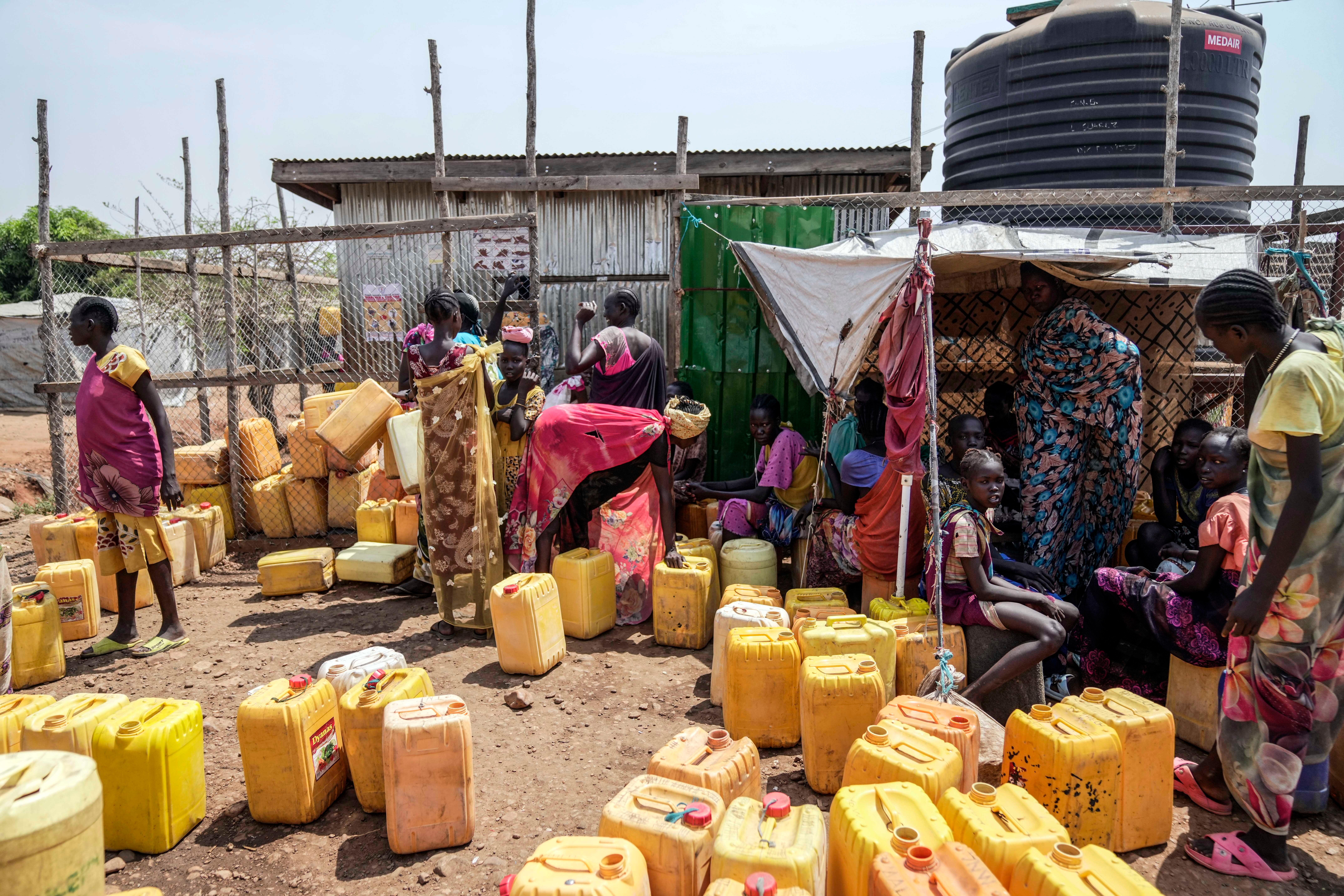Internally displaced people fetch water at a camp on the outskirts of Juba, South Sudan