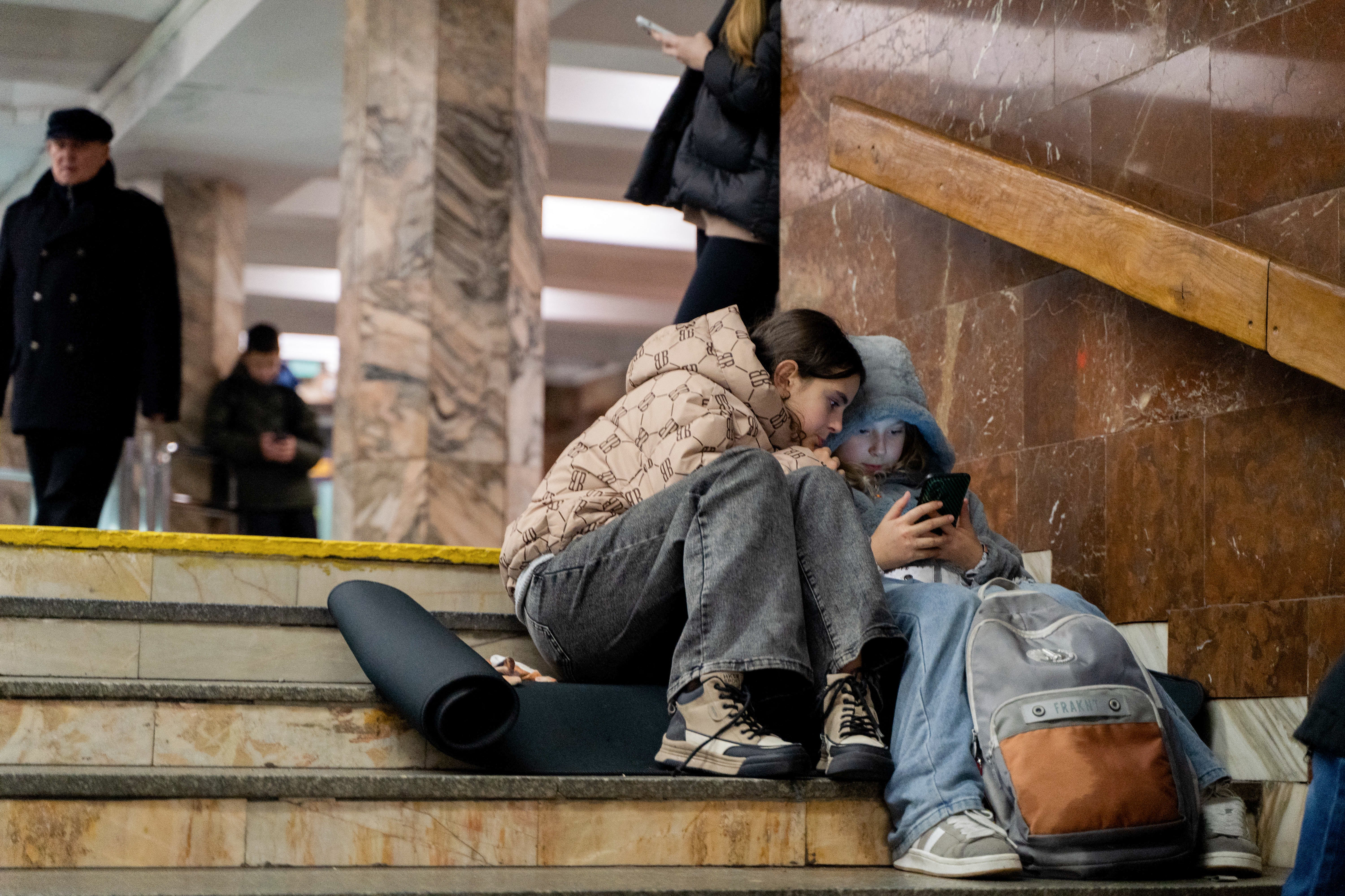 Children take shelter in a metro station during an airstrike alarm in Kyiv