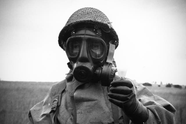 <p>Sergeant of the RAF Regiment wearing protective clothing and using a residual vapour detector at Porton Down in Wiltshire</p>