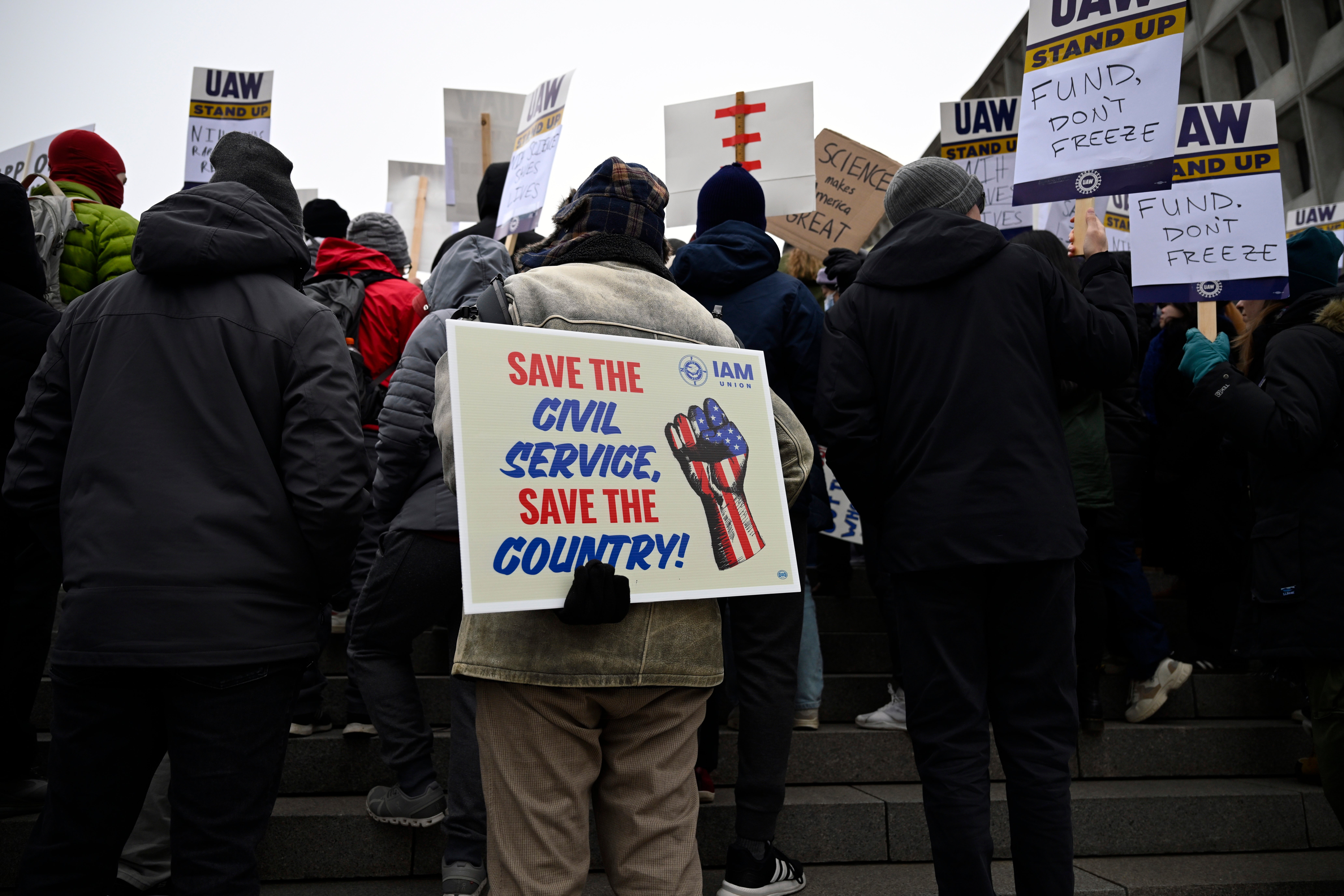 Federal workers rally outside the Department of Health and Human Services against Trump and Musk’s policies