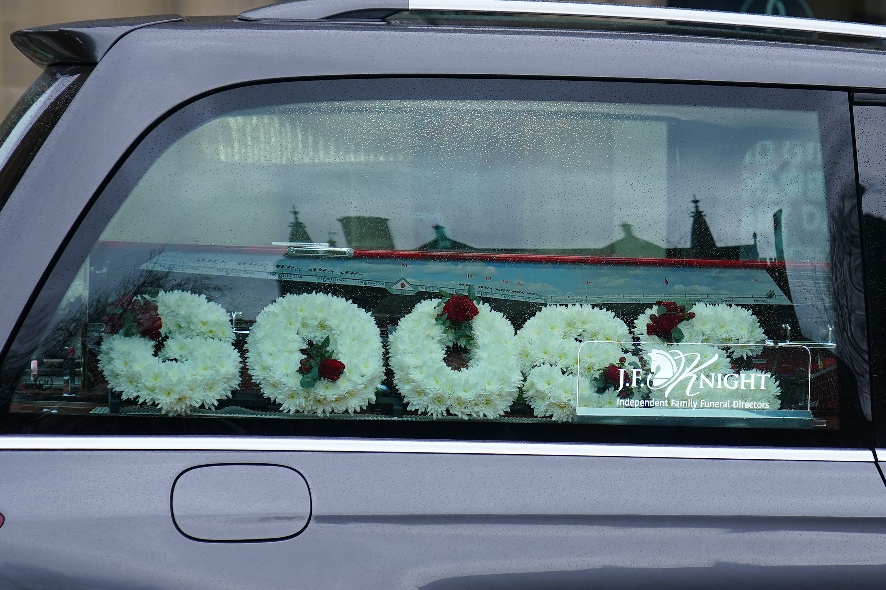 Flowers in the hearse carrying the coffin of Harvey Willgoose (Peter Byrne/PA)