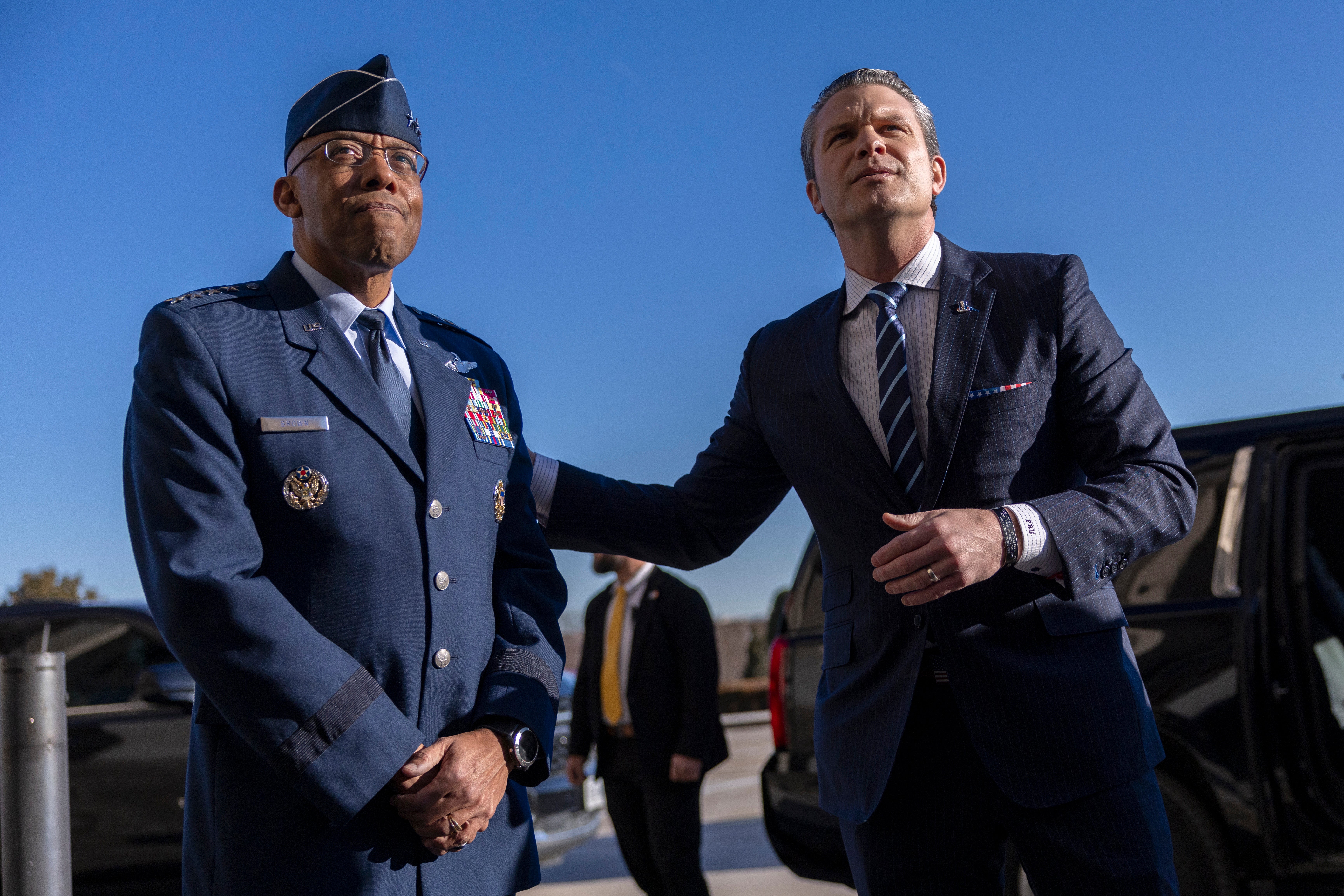 Charles Q. Brown Jr., left, greets Trump’s new Secretary of Defense, Pete Hegseth, as he arrives for his first day at the Pentagon
