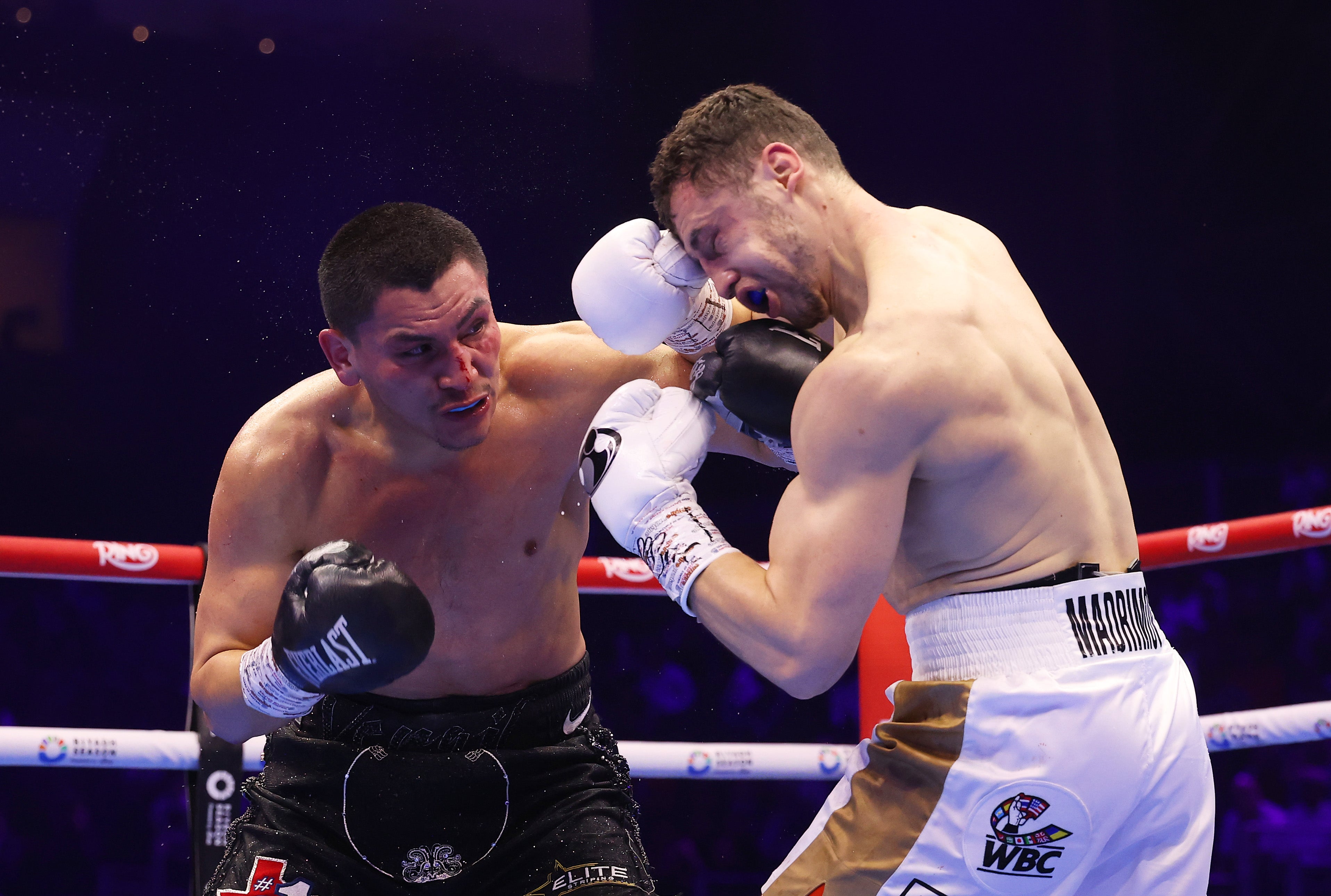 Virgil Ortiz (left) punches Israil Madrimov in their super welterweight fight